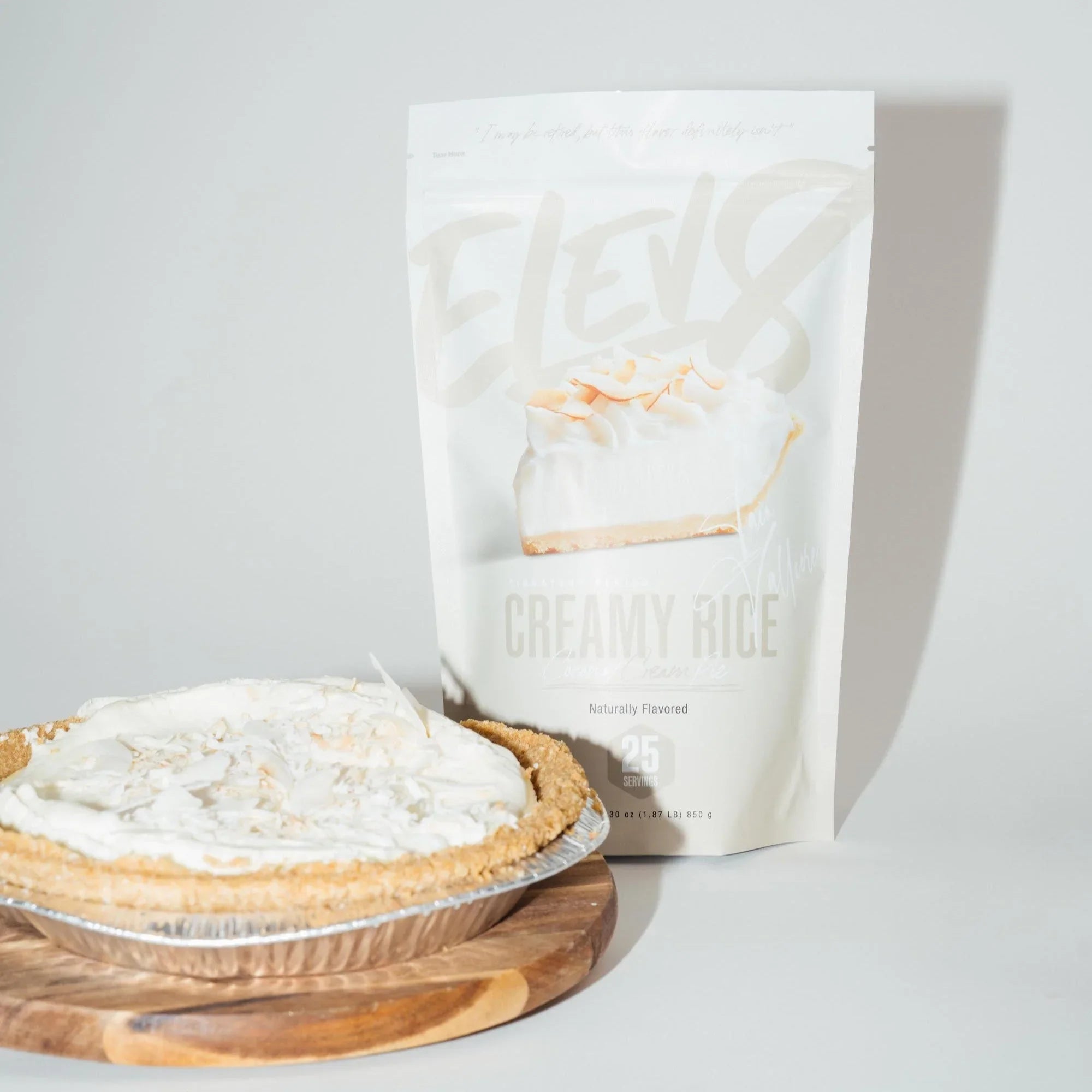 Creamy rice pie in a graham crust on cutting board with Elev8 Creamy Rice mix pouch