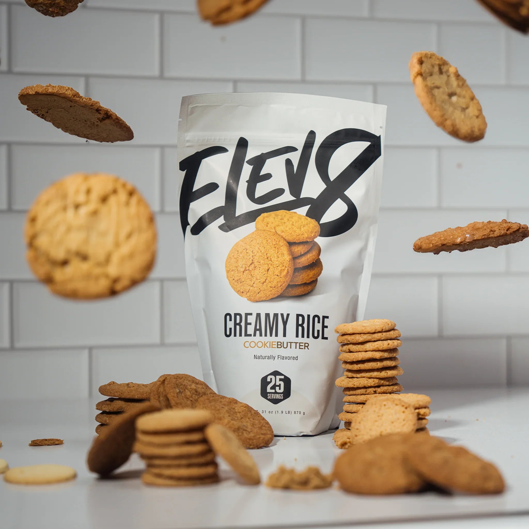 Elev8 Creamy Rice Cookie Butter cereal pouch with cookies and white tiled background.