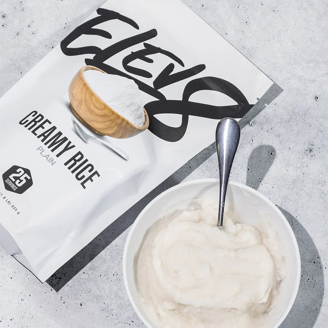 Elev8 Creamy Rice Plain packet with bowl of creamy rice cereal and spoon on gray surface