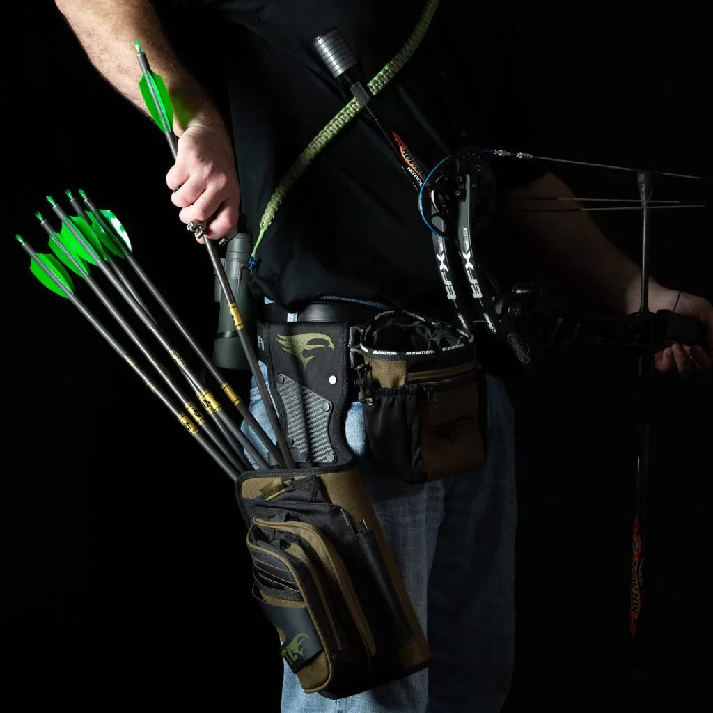 Archer with bow, hip quiver, green arrows, and archery gear against black background