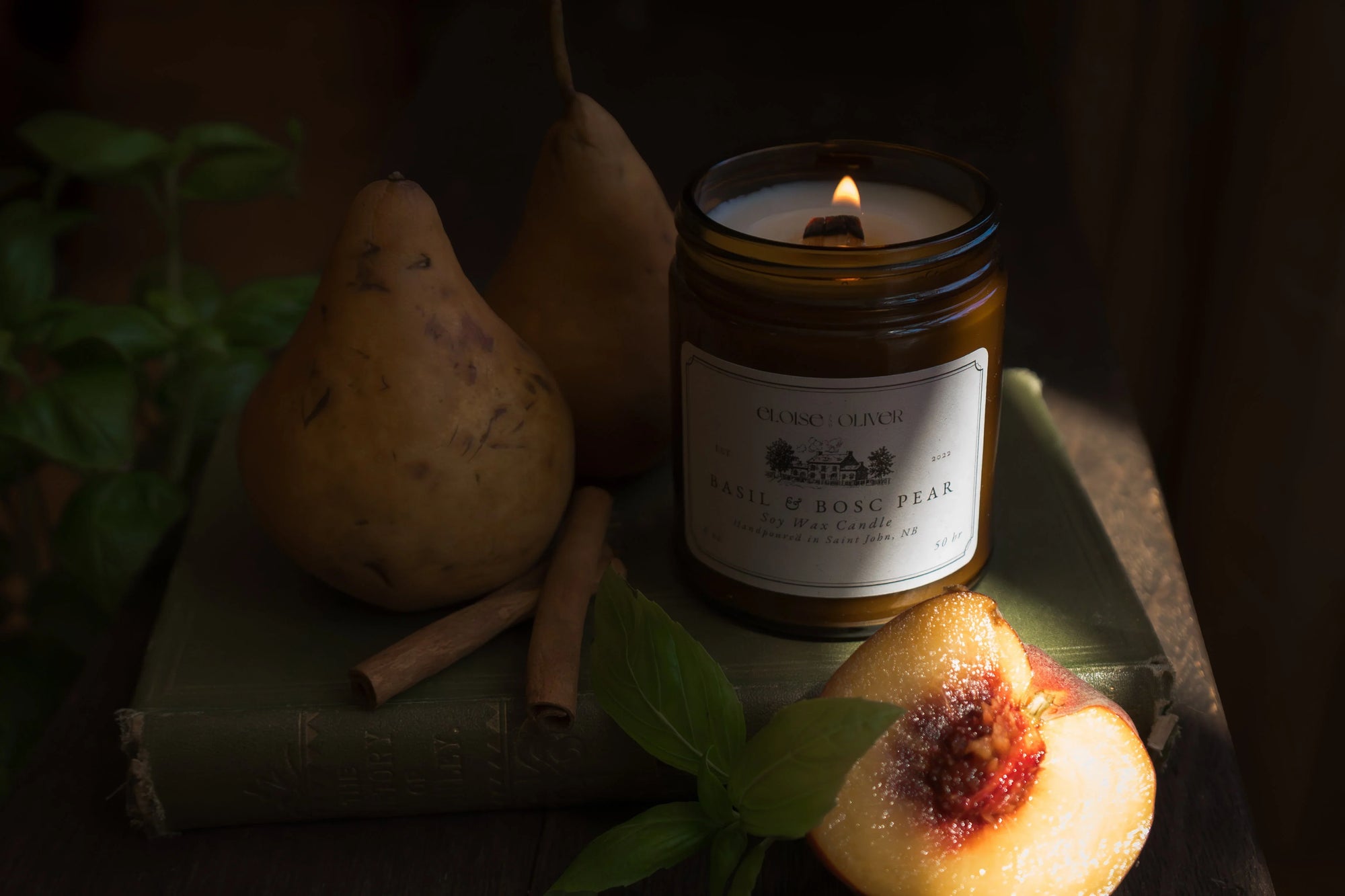 Basil and bosc pear soy candle with pears, cinnamon sticks, basil leaves, and sliced peach