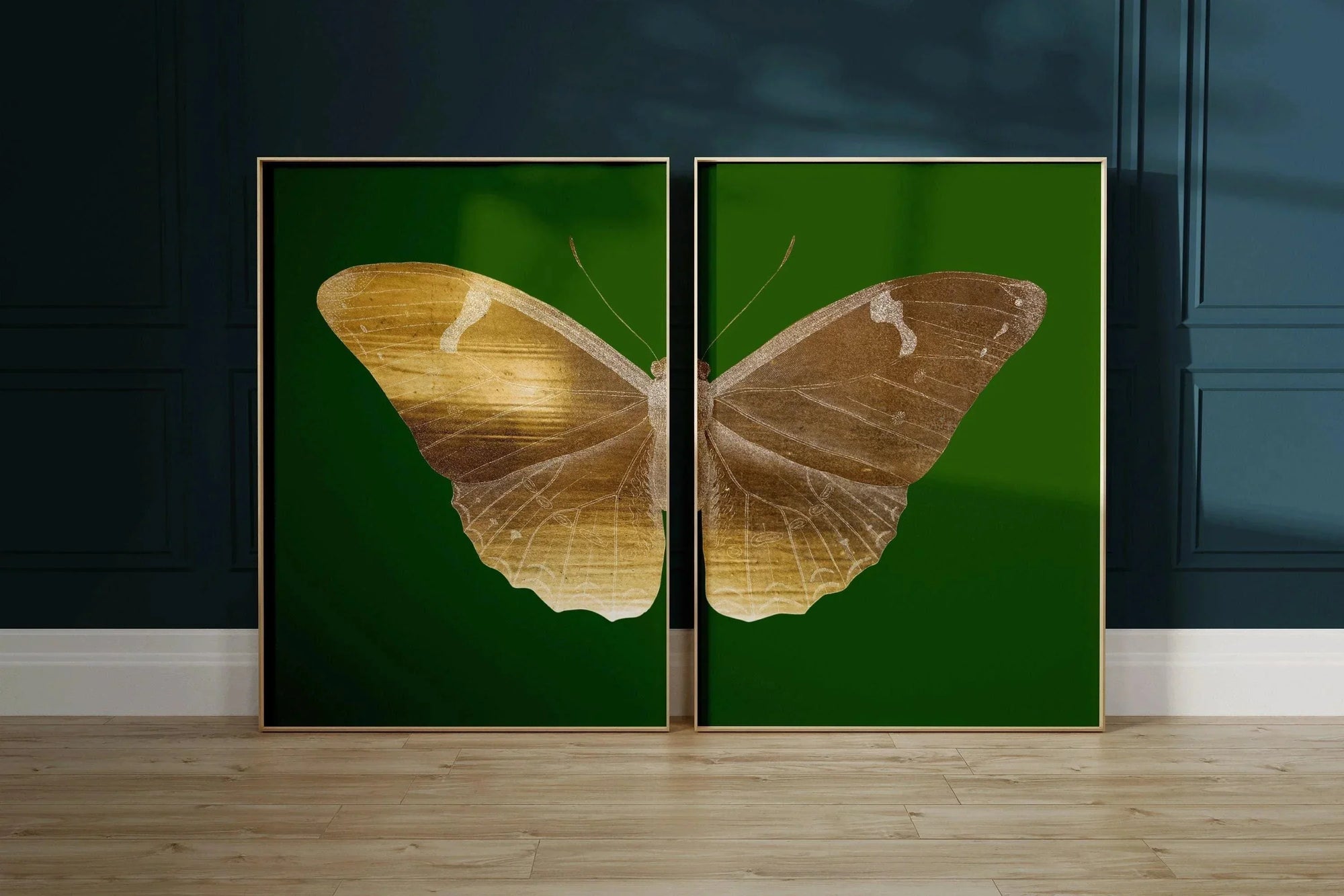 Duo vintage emerald green and gold butterfly art prints in gold frames on wooden floor