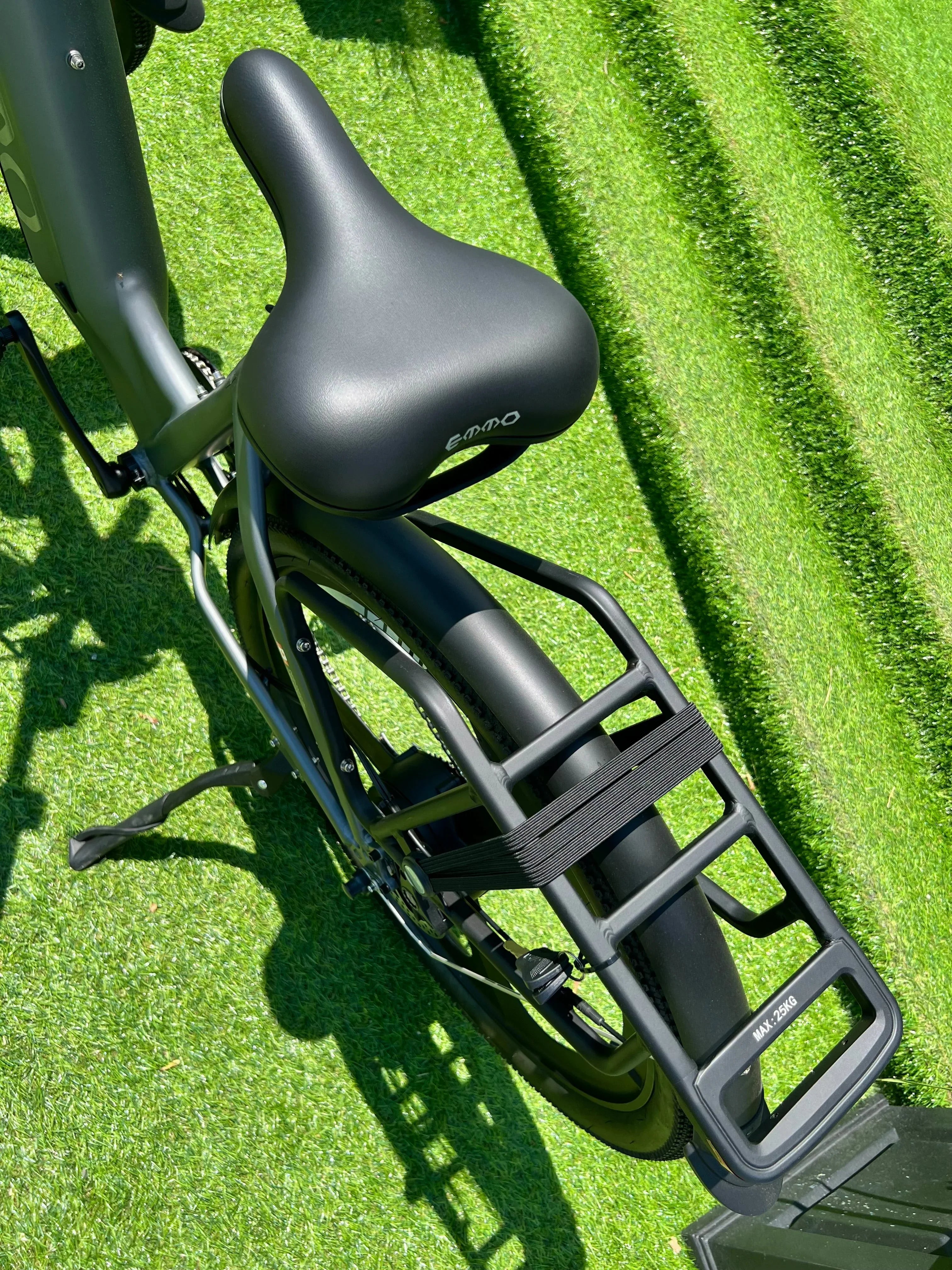 EMMO electric bike rear seat and cargo rack on green artificial grass