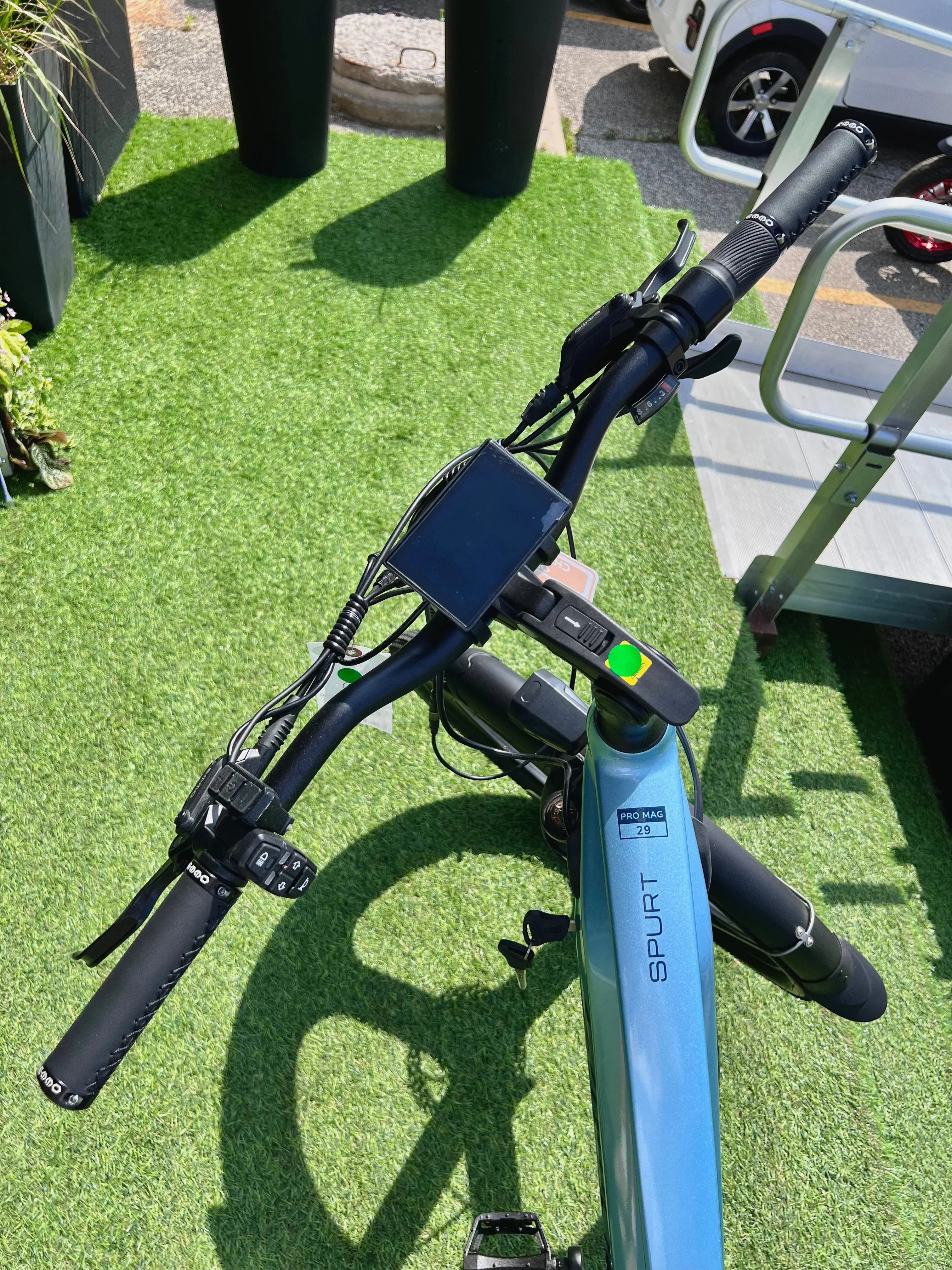 Spurt electric bike handlebar and display on artificial grass outdoors