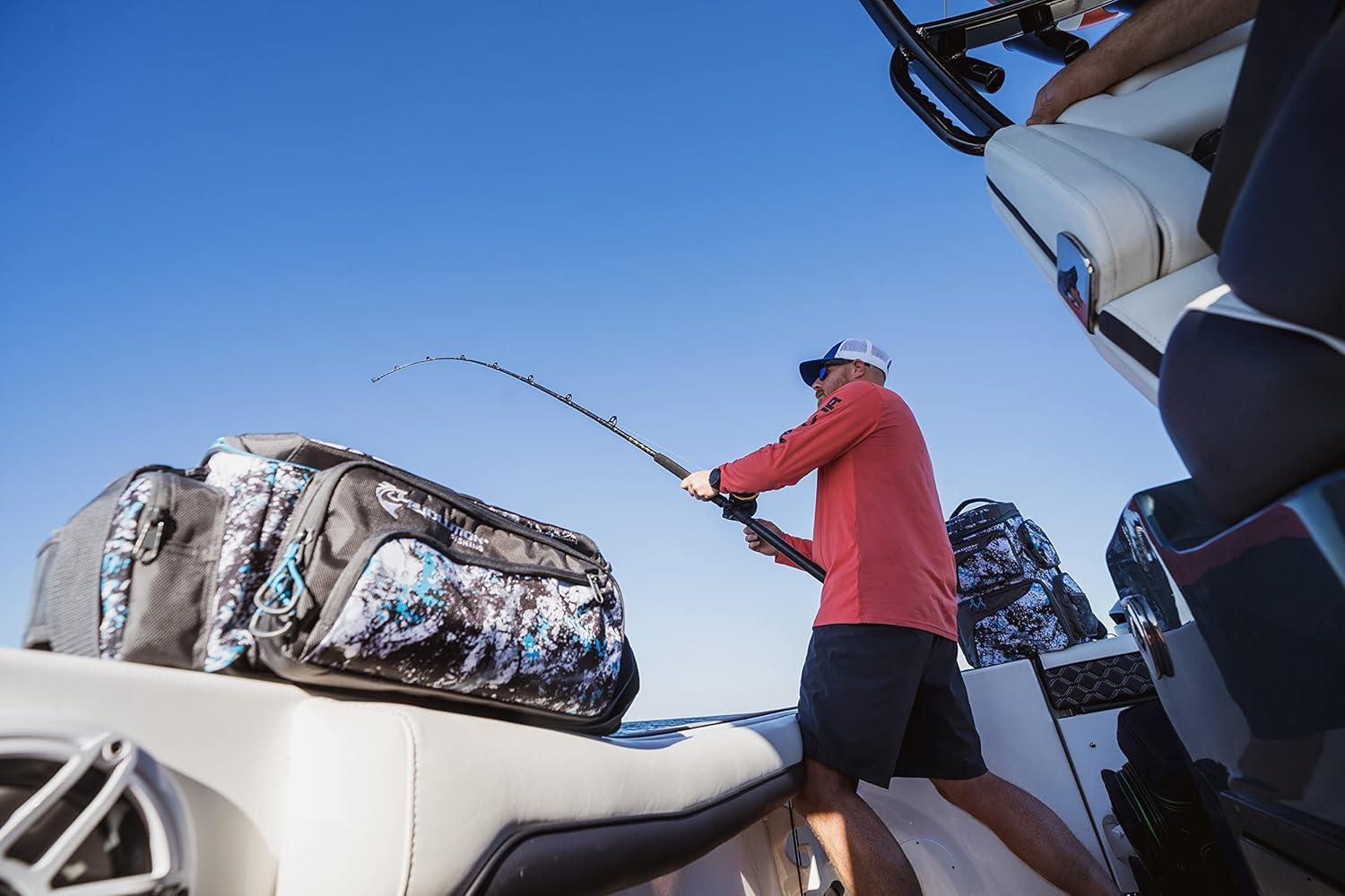 Man fishing on a boat with camouflage tackle bags against a clear blue sky