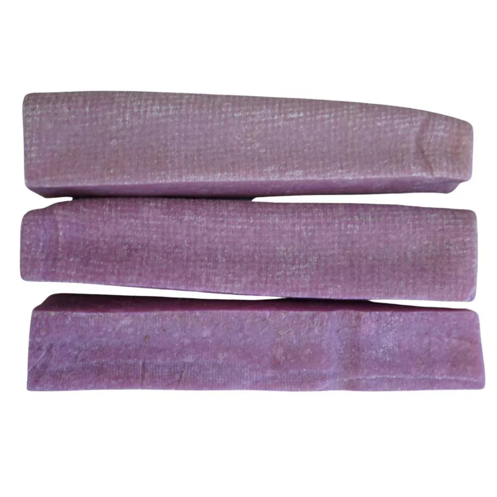 Three extra-large blueberry Himalayan yak chews with a purple hue on a white background