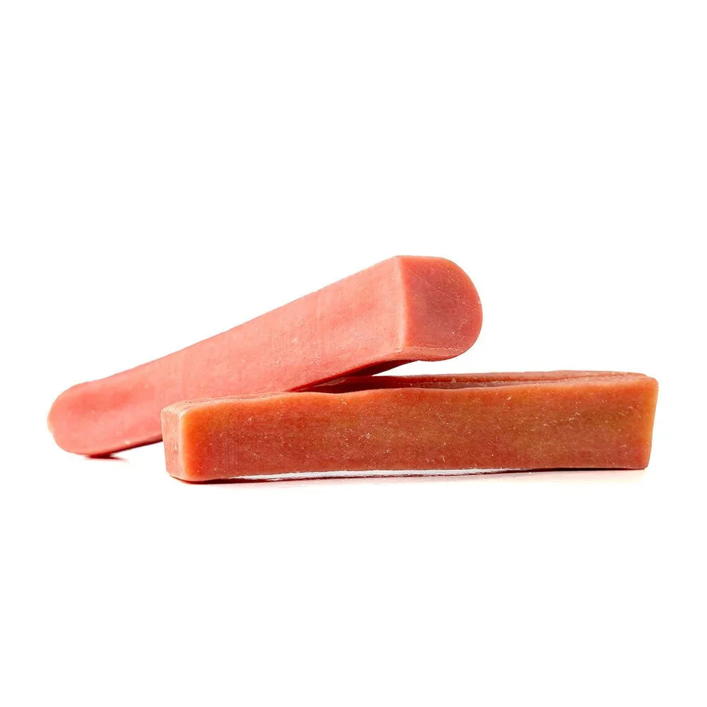 Two extra large strawberry Himalayan yak chews for dogs on white background
