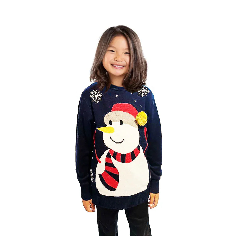 Smiling girl wearing navy blue Christmas sweater with snowman and snowflake design