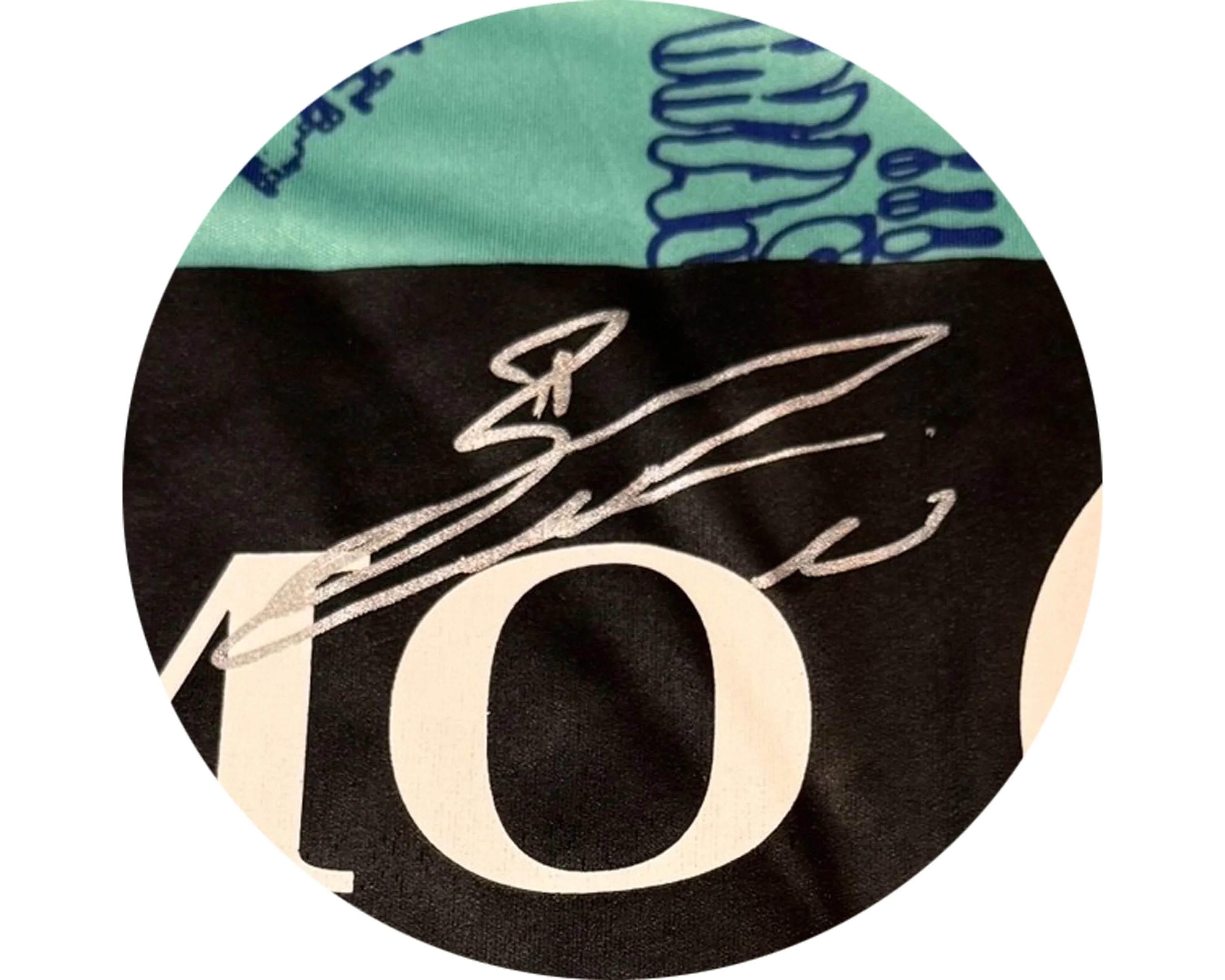 Silver autograph on black and teal fabric with white print and abstract blue design