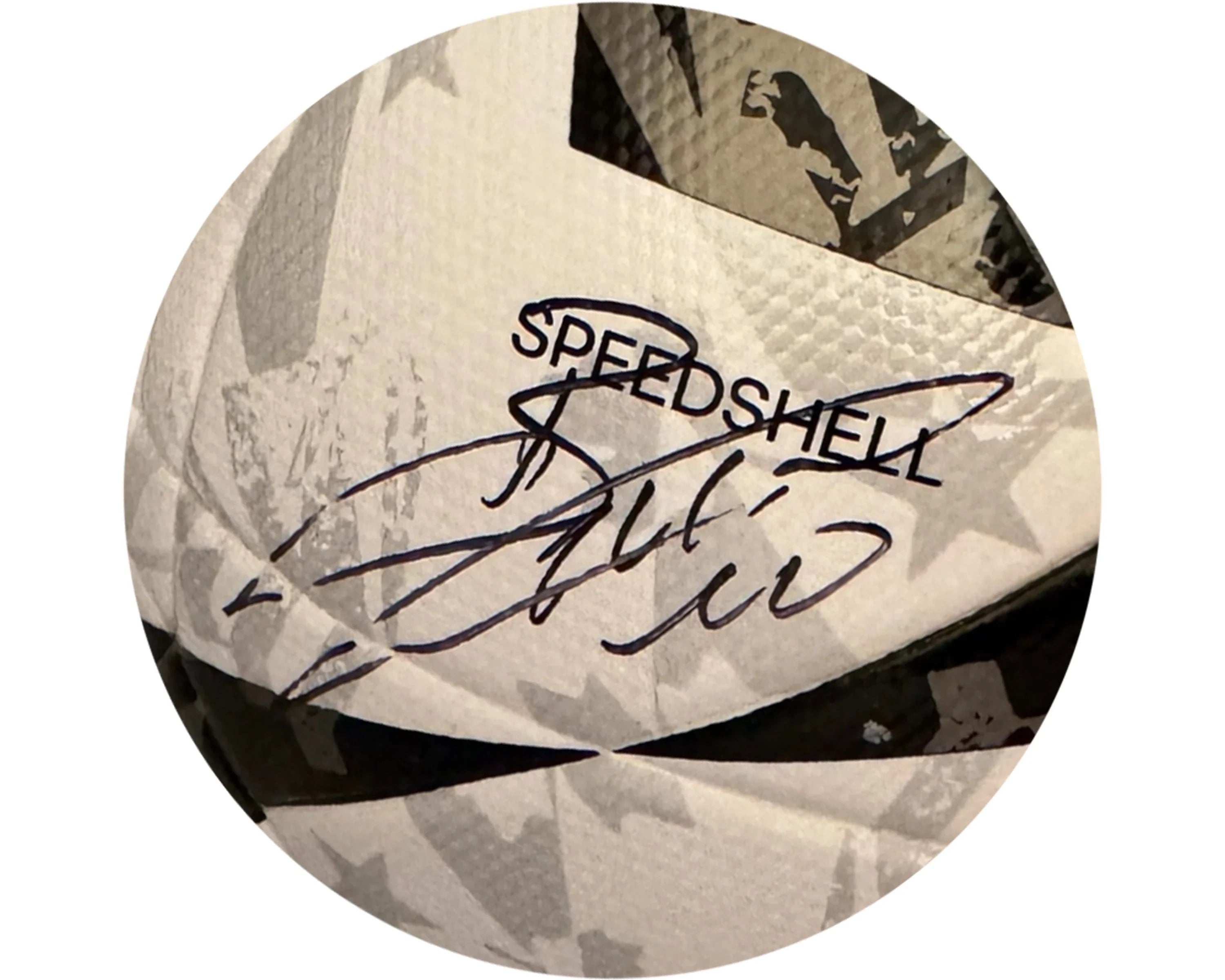 Close-up of a white soccer ball with black pattern, signature, and 'SPEEDSHELL' text visible