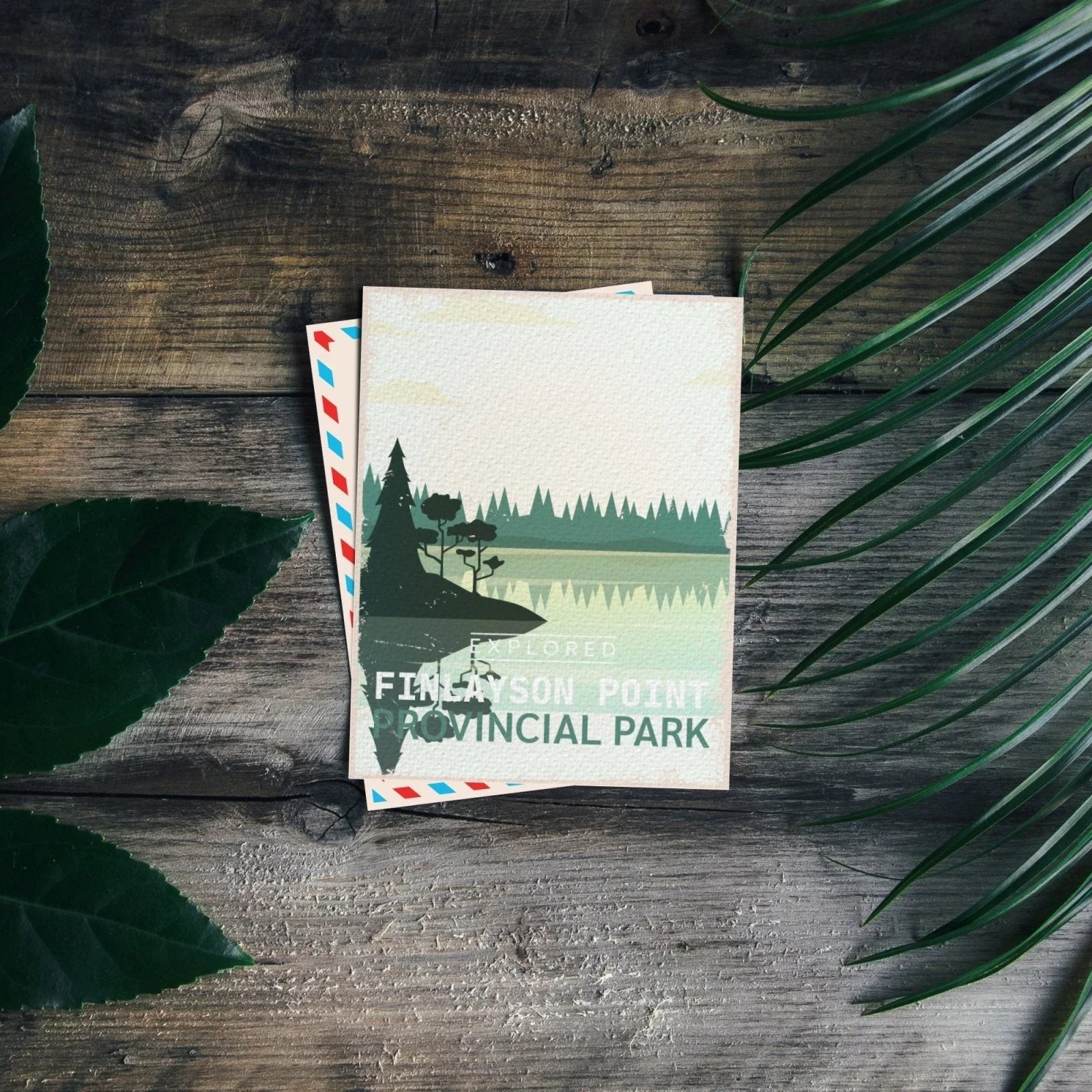 Finlayson Point Ontario Provincial Park postcard on rustic wood with green leaves