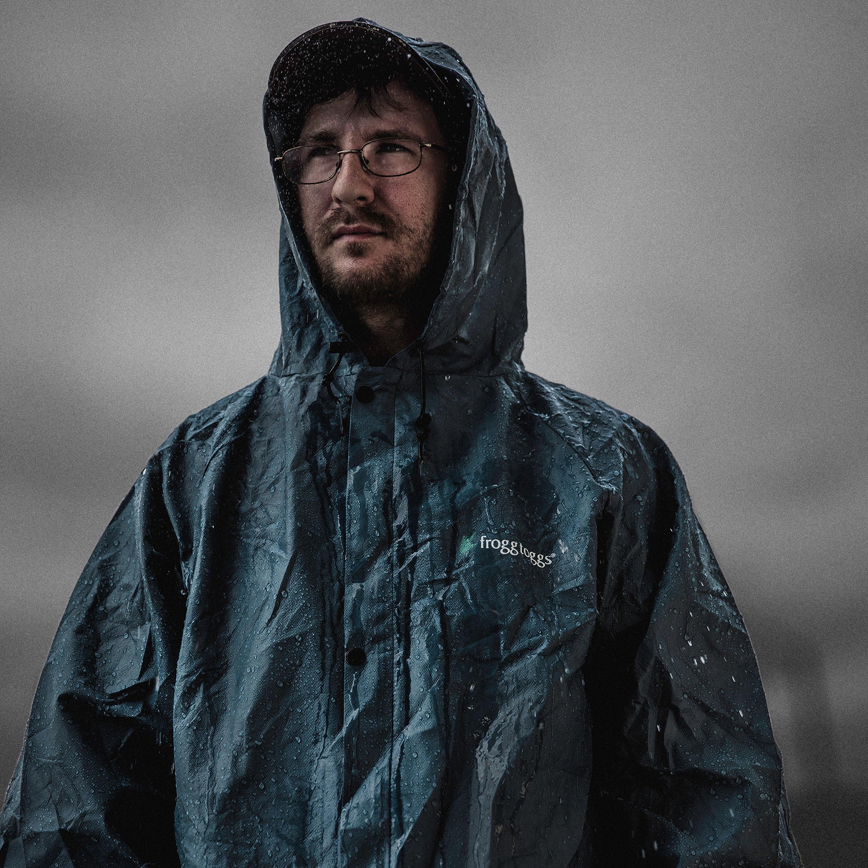 Man wearing Frogg Toggs Ultra-Lite2 waterproof rain suit in rainy outdoor setting