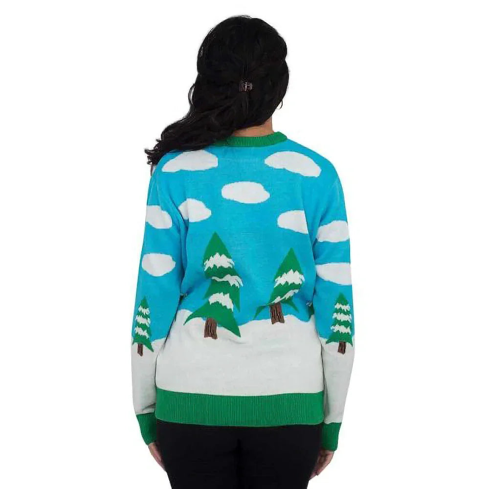 Back view of a woman wearing a blue ugly Christmas sweater with snowy trees and clouds