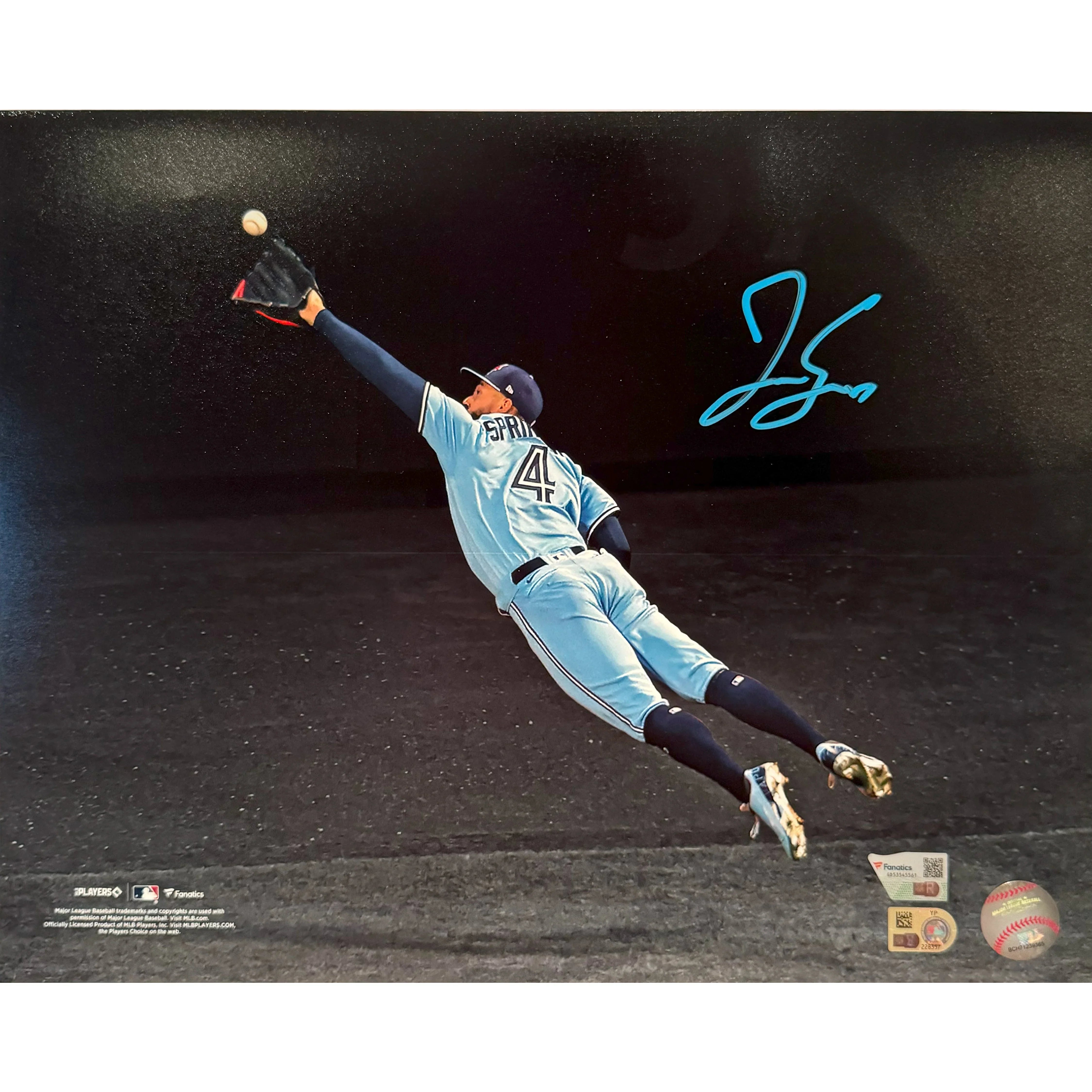 Baseball player in blue uniform mid-air catching ball, signed sports memorabilia photo