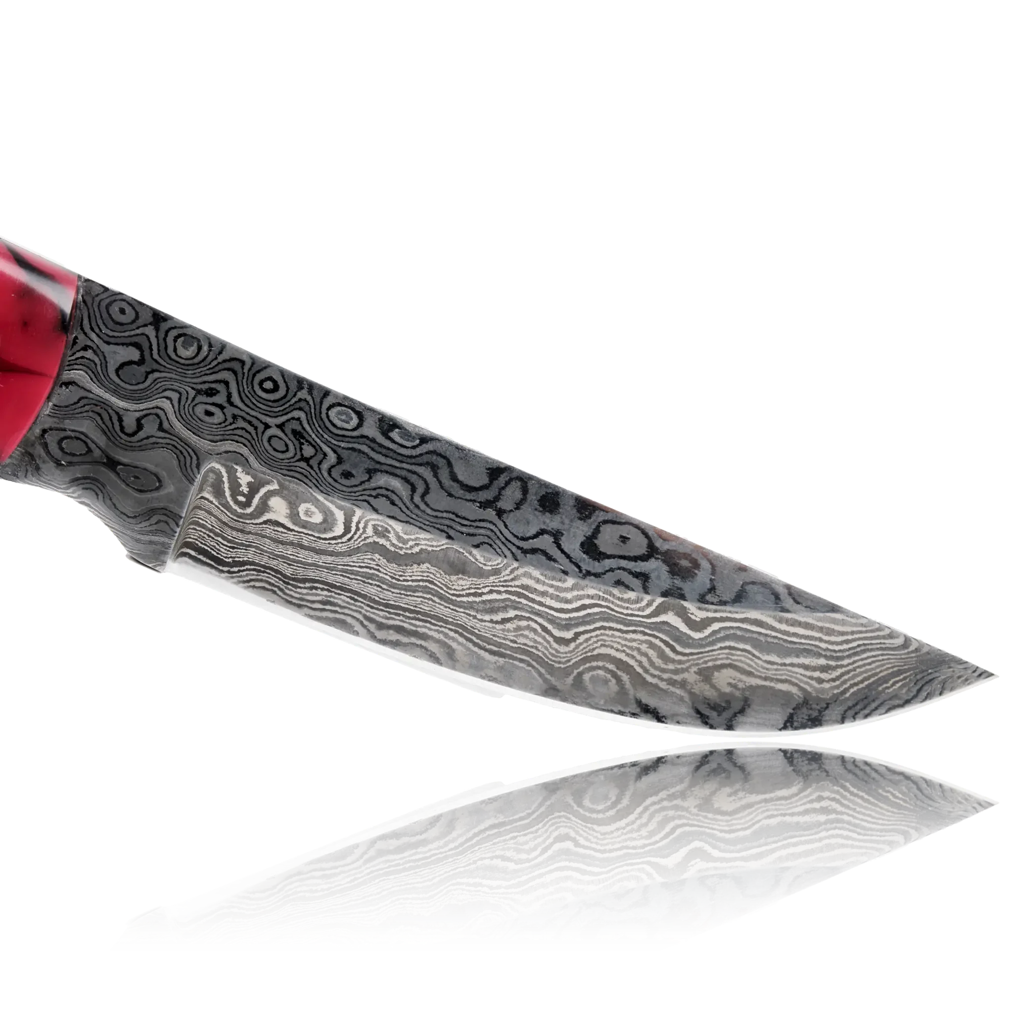 Damascus steel knife blade with red handle on reflective black background