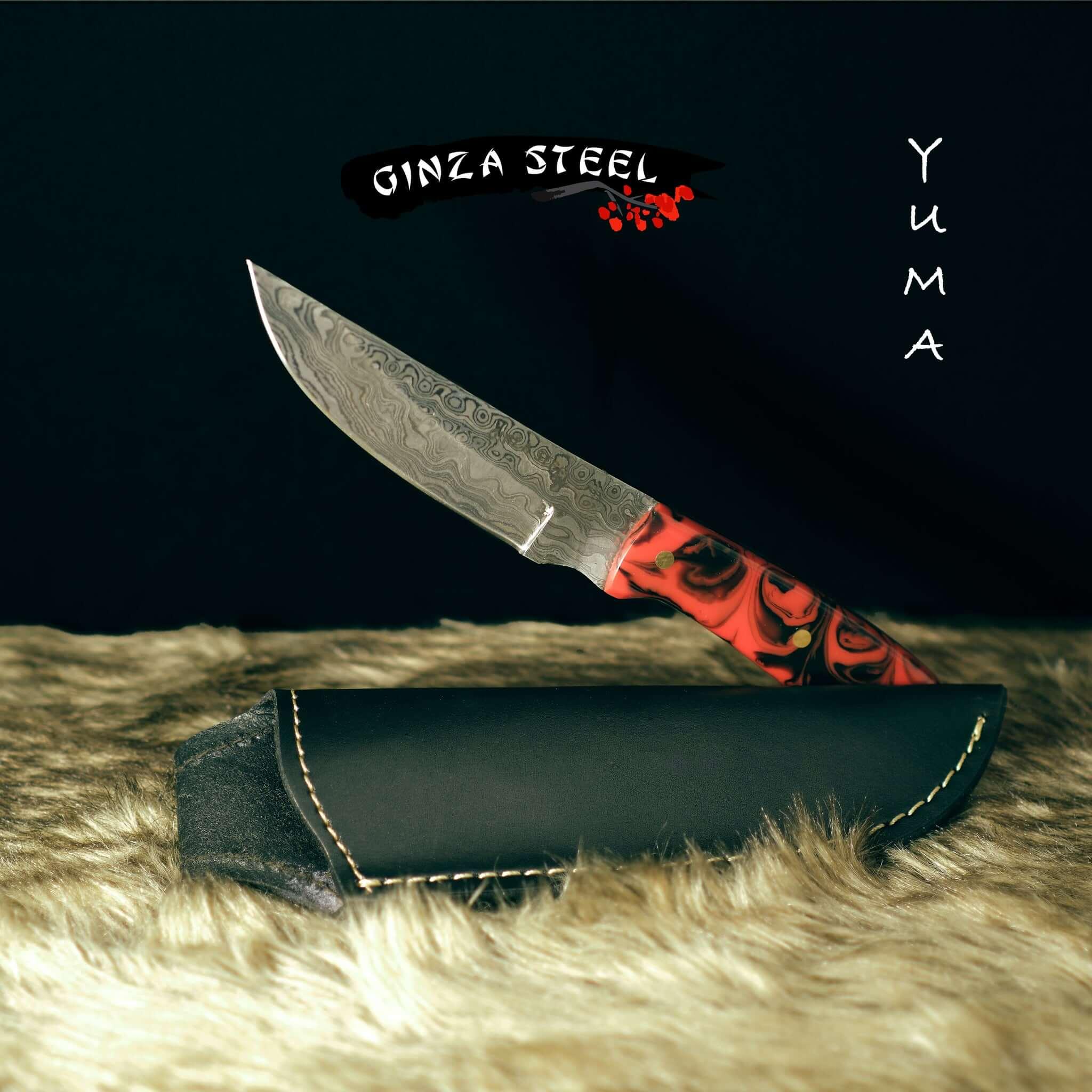 Ginza Steel Yuma Damascus knife with red-black handle and leather sheath on fur