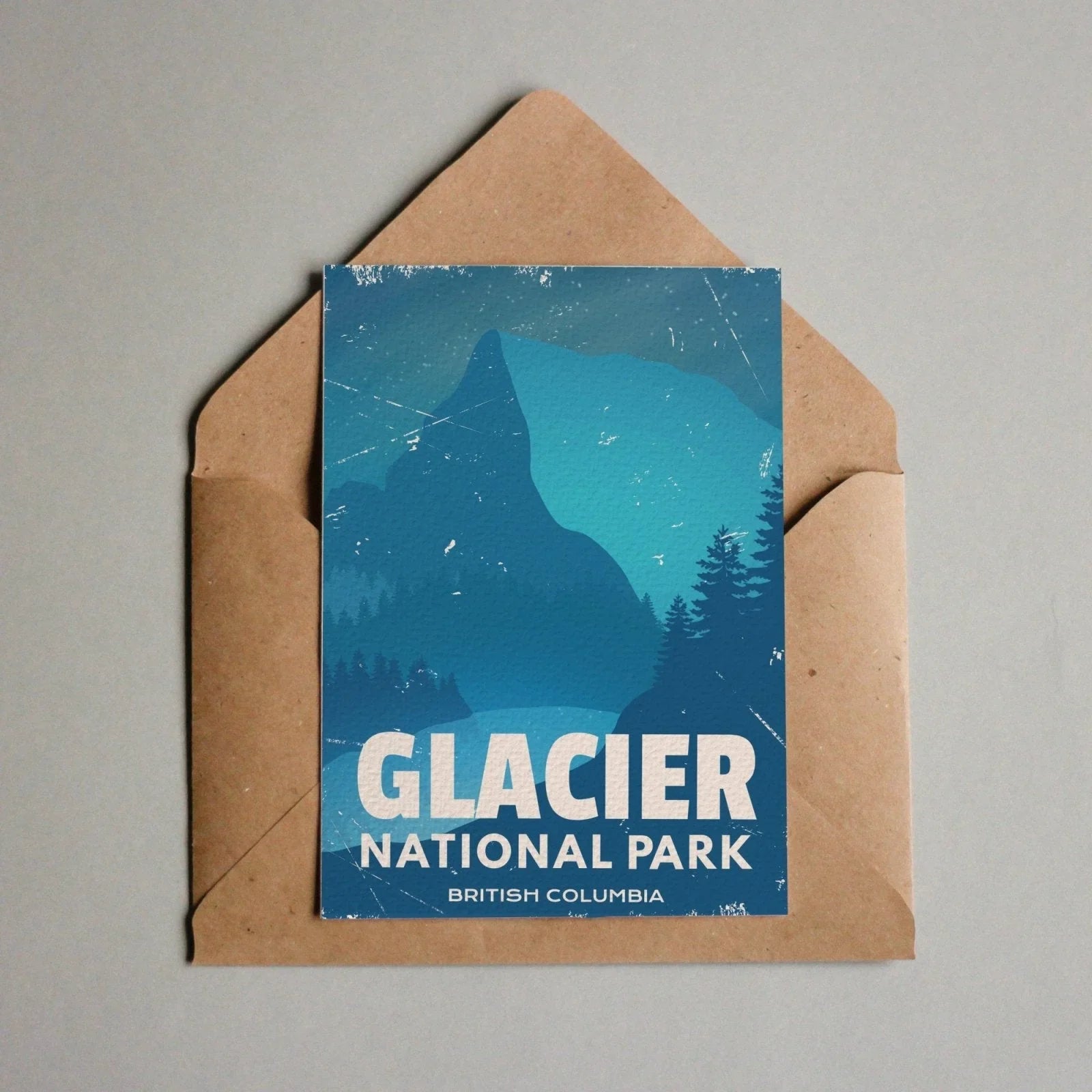 Glacier National Park postcard with blue mountain and forest in brown envelope