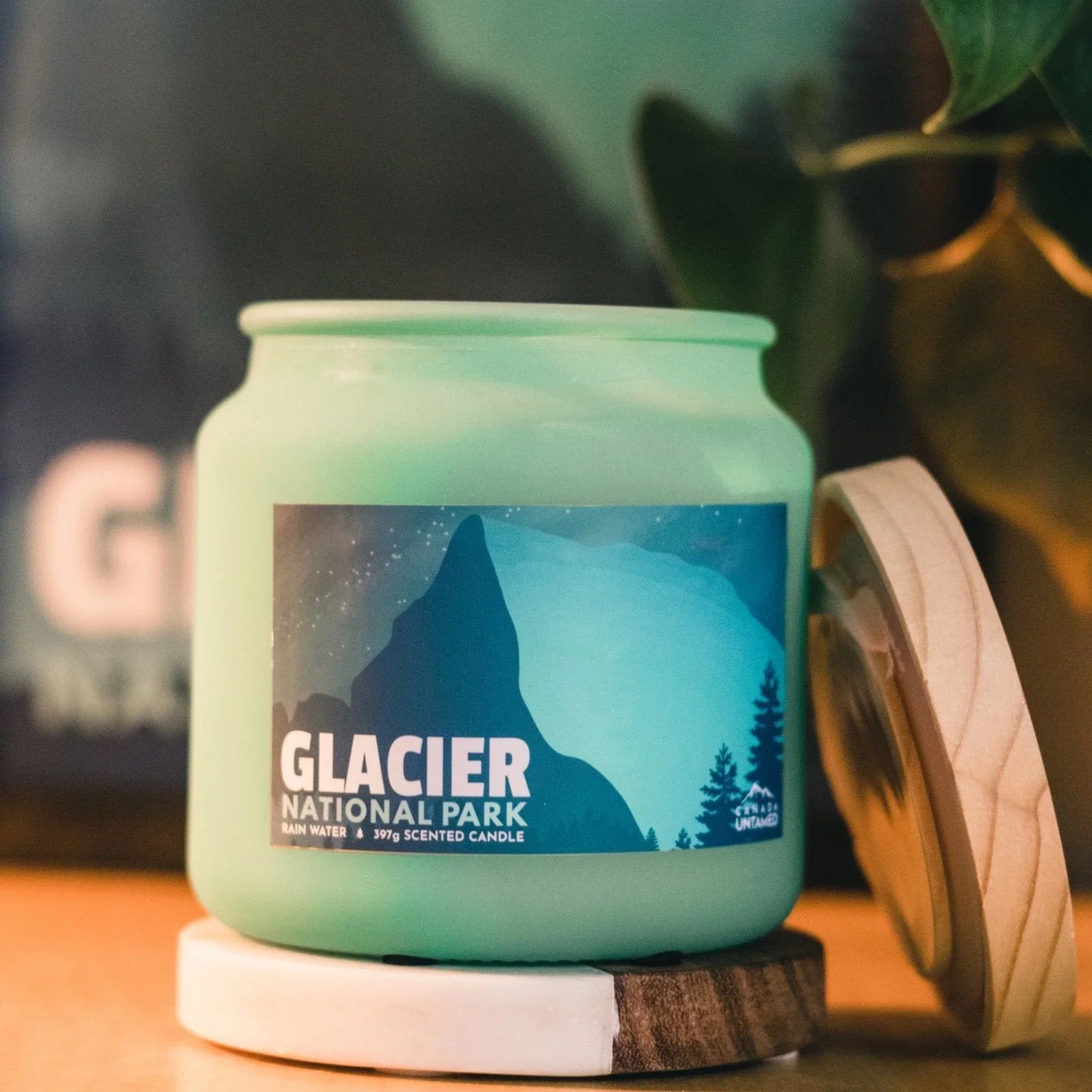 Glacier National Park rain water scented candle in green jar with mountain label