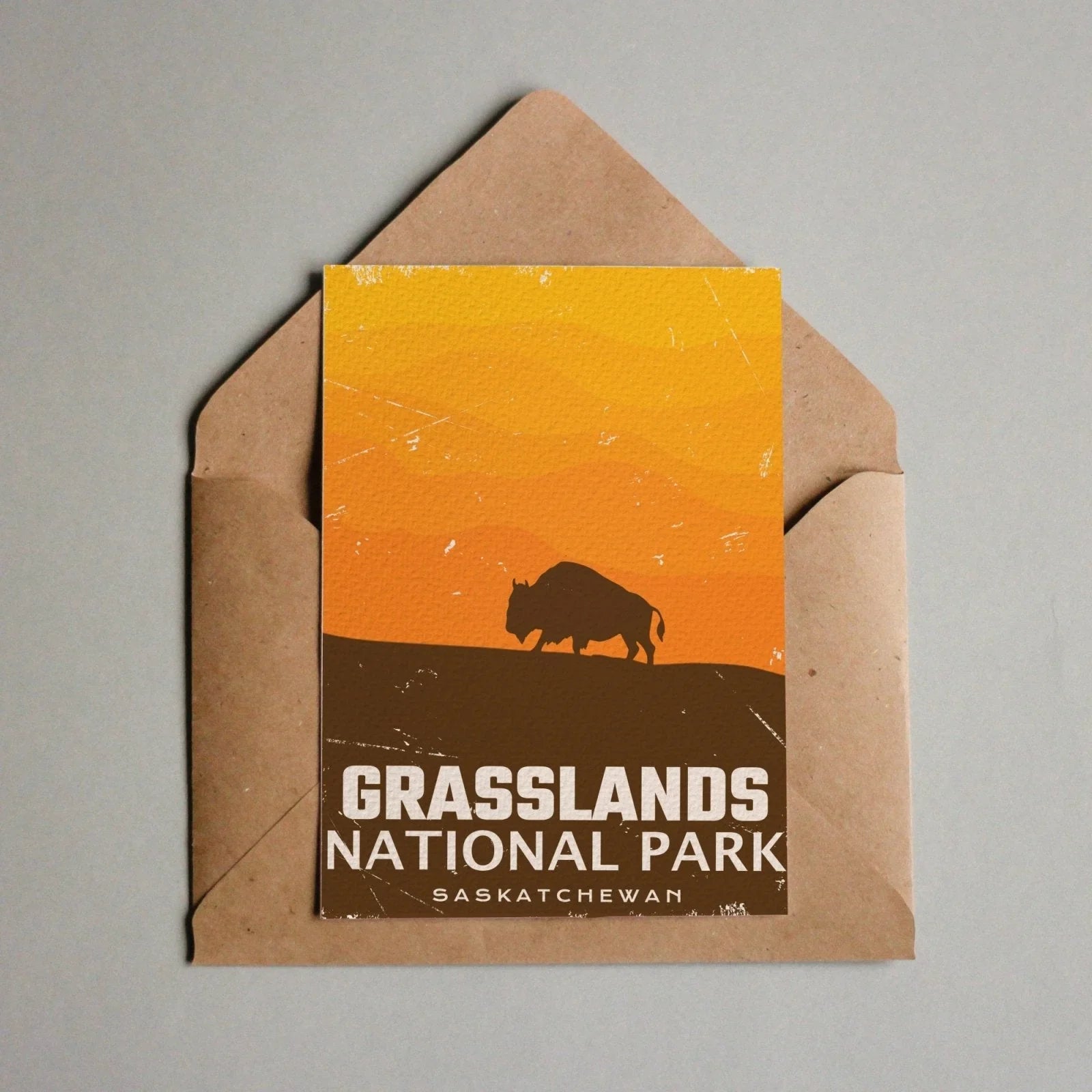 Grasslands National Park Saskatchewan postcard with bison silhouette and orange sunset