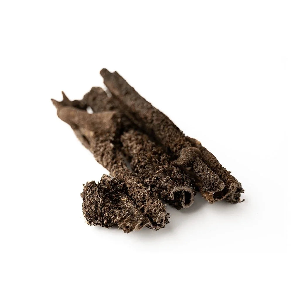Dried green beef tripe dog treat on white background