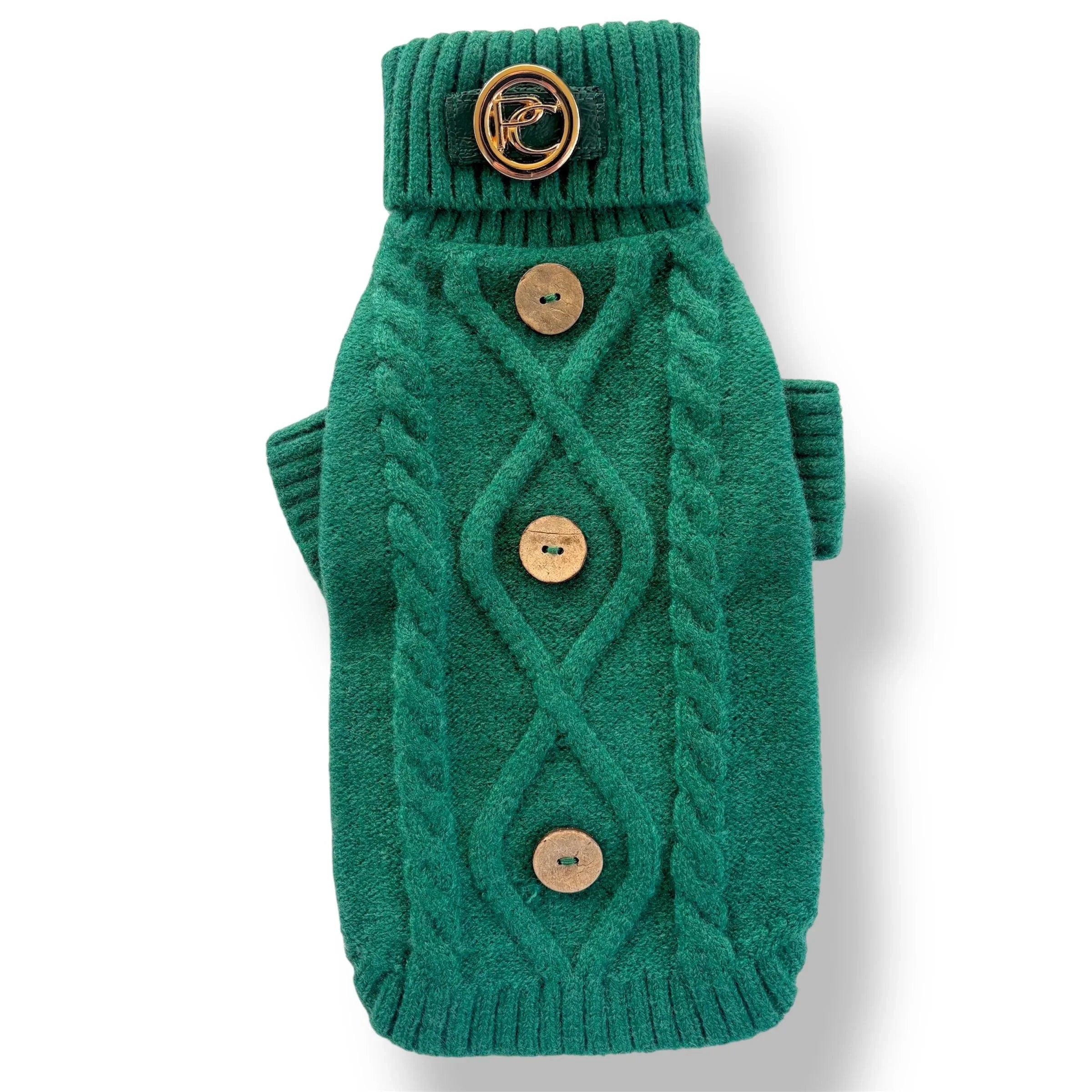 Green cable knit dog sweater with wooden buttons and gold decorative collar emblem