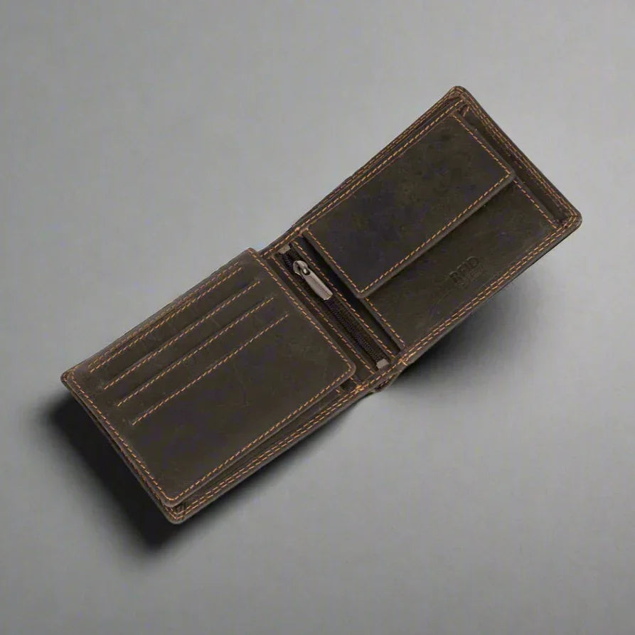 Open brown leather wallet with card slots and coin pocket on gray background