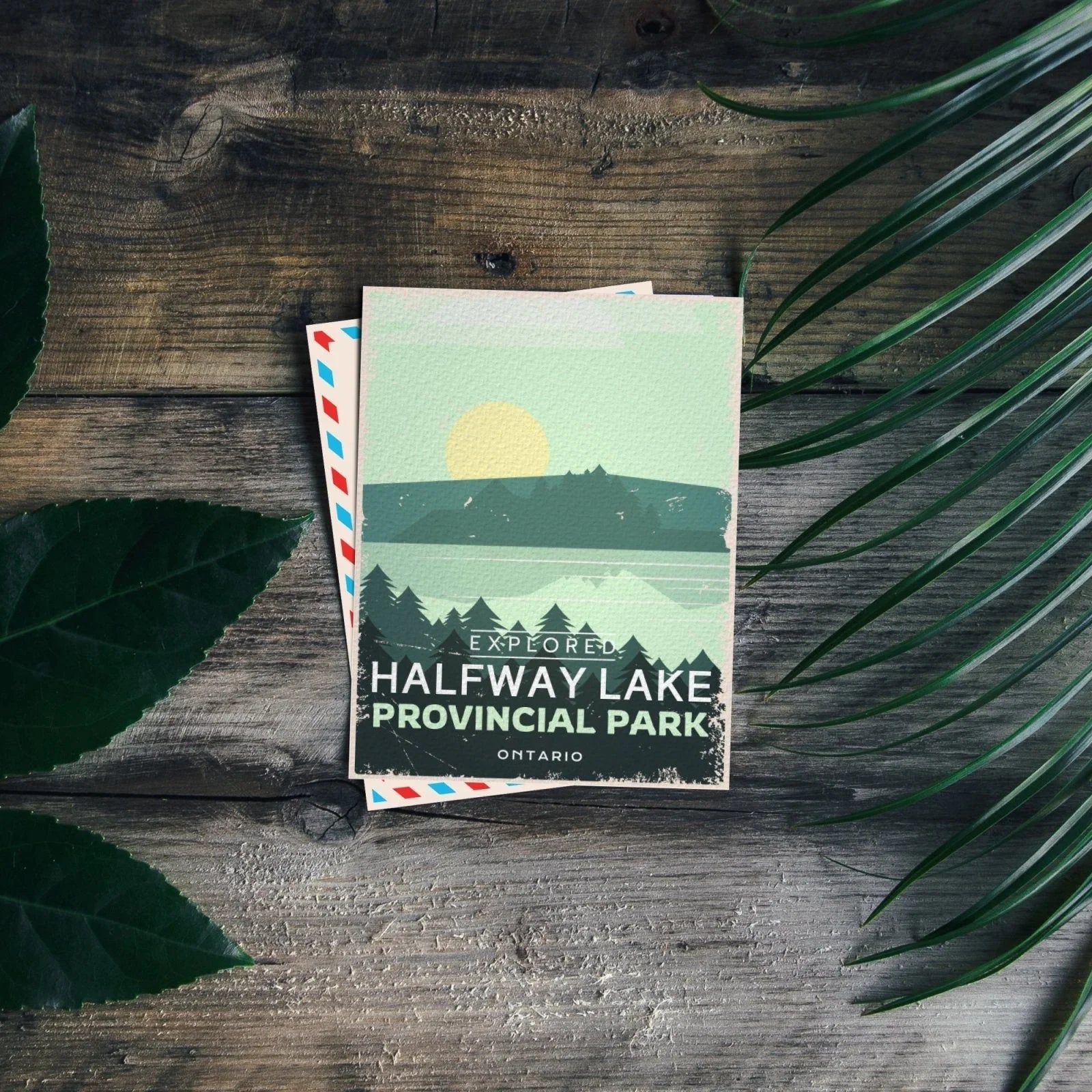 Halfway Lake Provincial Park Ontario postcard on rustic wood with green leaves