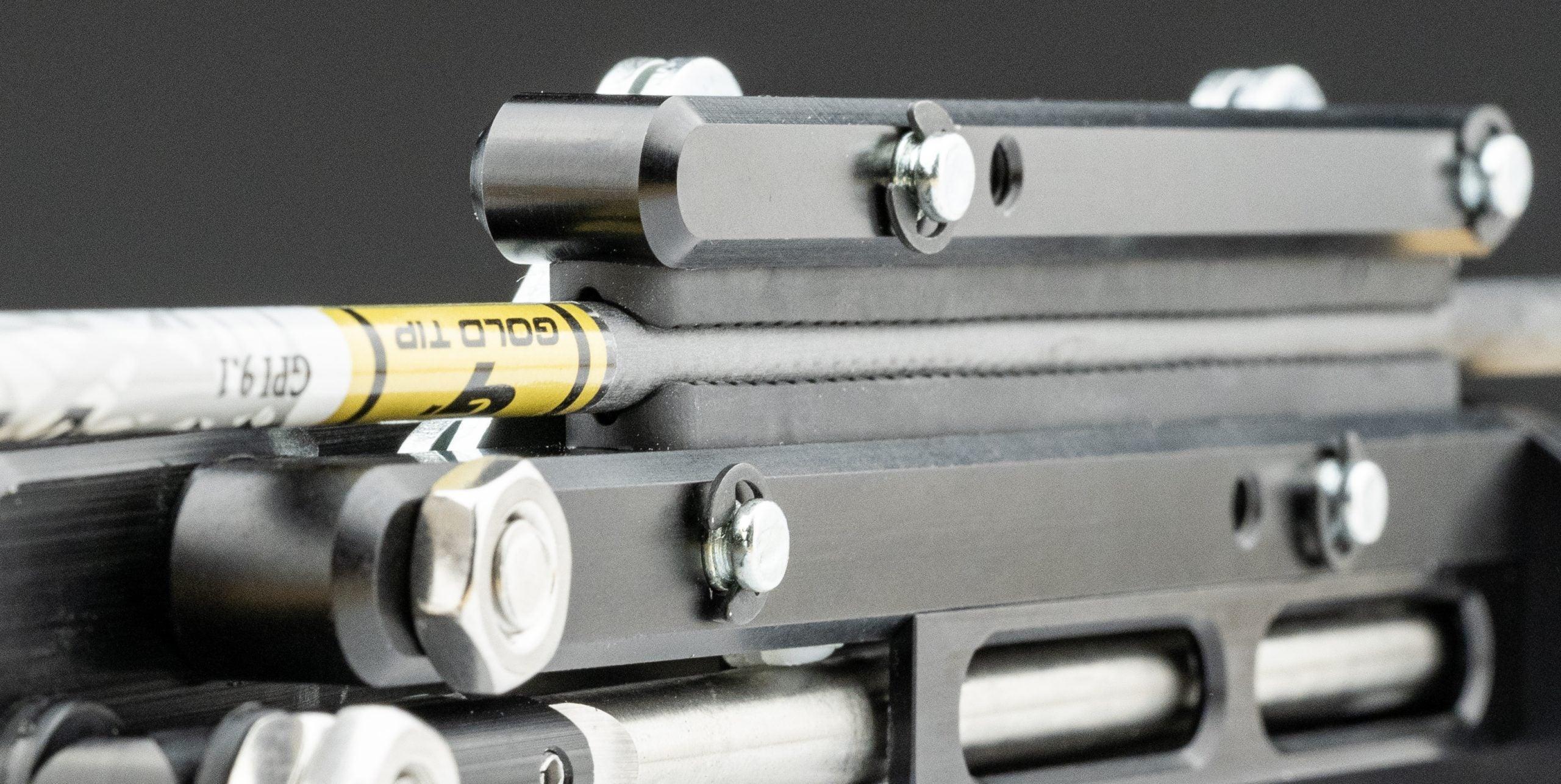 Close-up of Hamskea Arojac 2.0 arrow puller gripping an archery arrow shaft