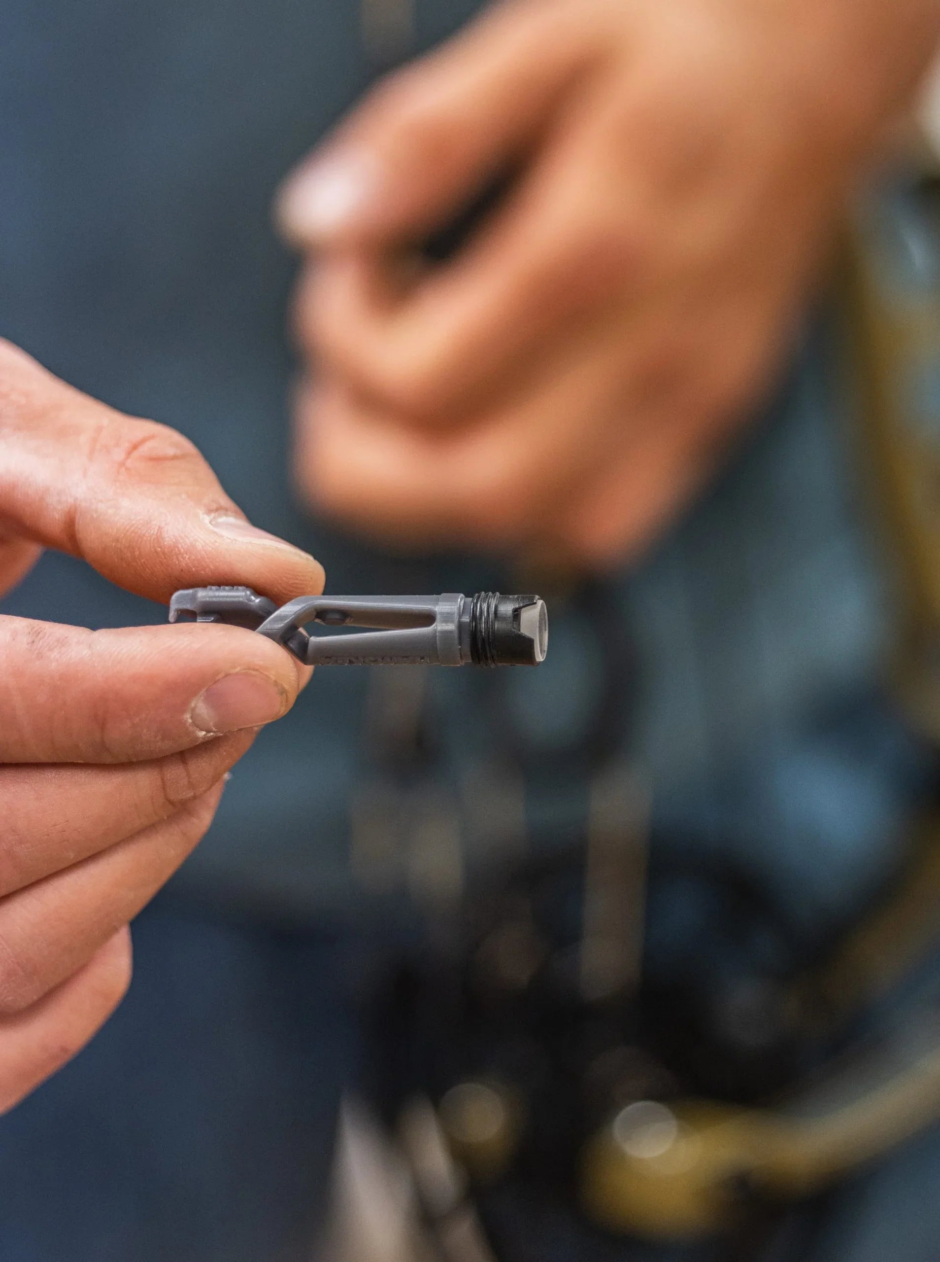 Hand holding an installation tool with verifier lens and lens cartridge