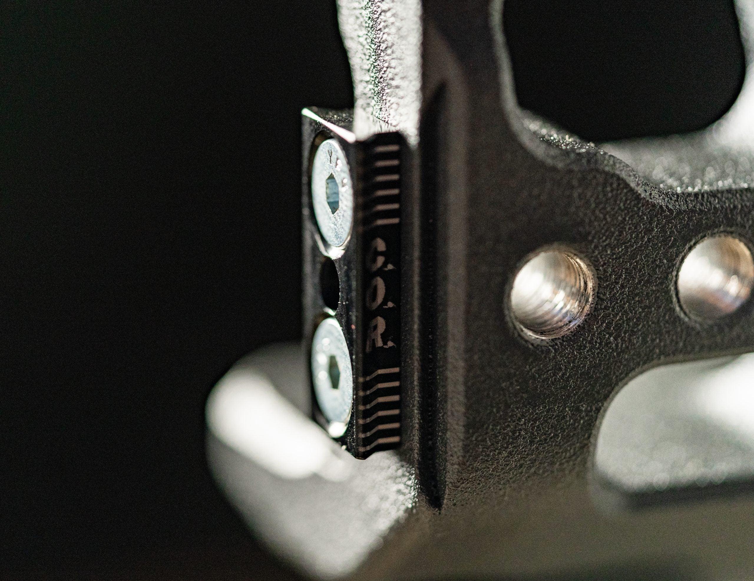 Close-up of Hamskea Archery Epsilon C.O.R. mount riser interface with metal screws.