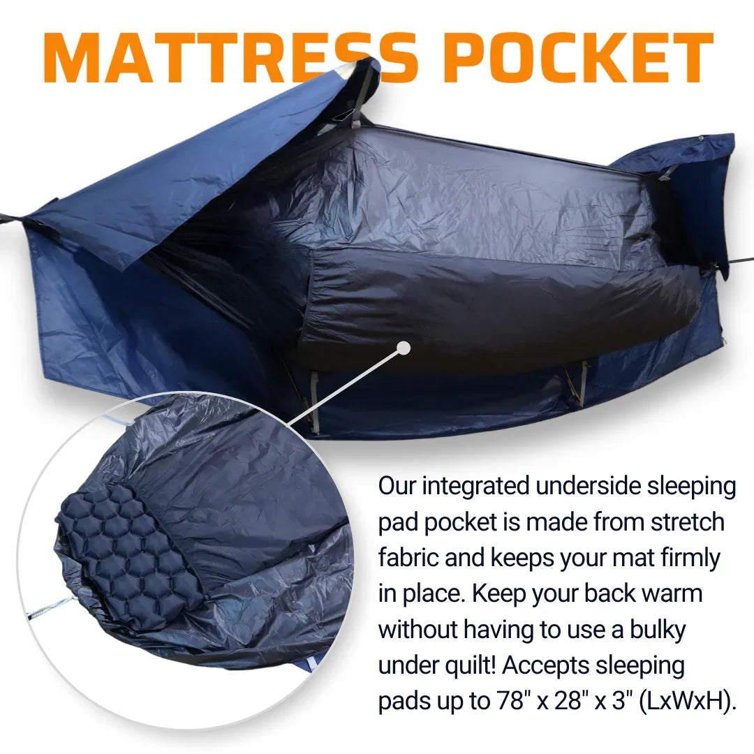 Blue hammock with integrated mattress pocket for sleeping pad, shown outdoors.