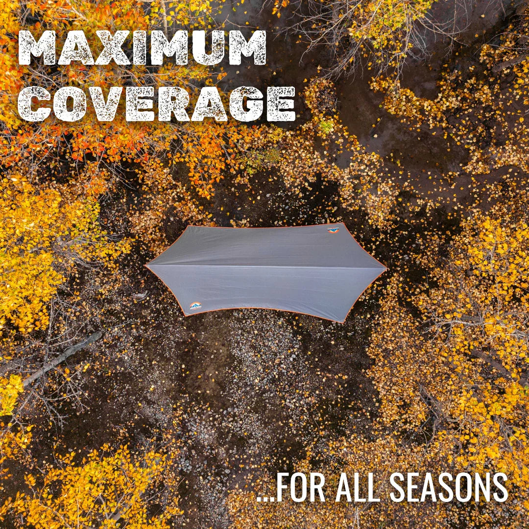 Aerial view of a large camping tarp on autumn forest floor, maximum coverage for all seasons.