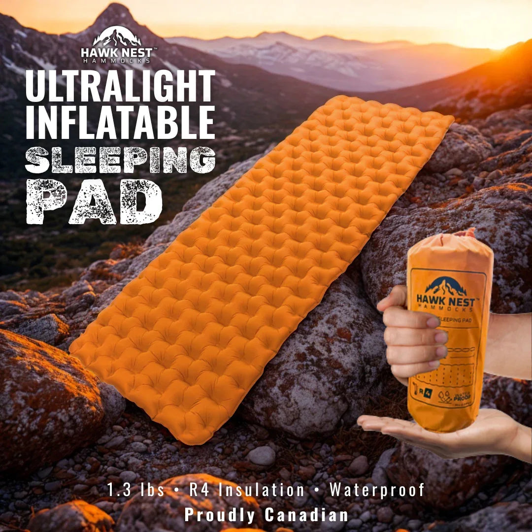 Orange ultralight inflatable sleeping pad on mountain rocks at sunset, Hawk Nest brand shown.
