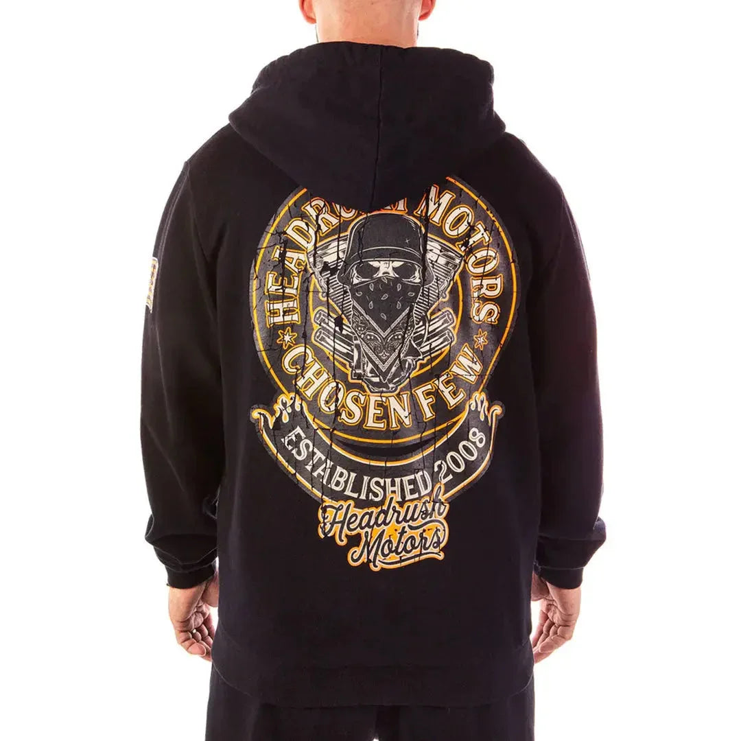 Man wearing black Headrush Motors Mechanic zip-up hoodie with motorcycle club graphic on back