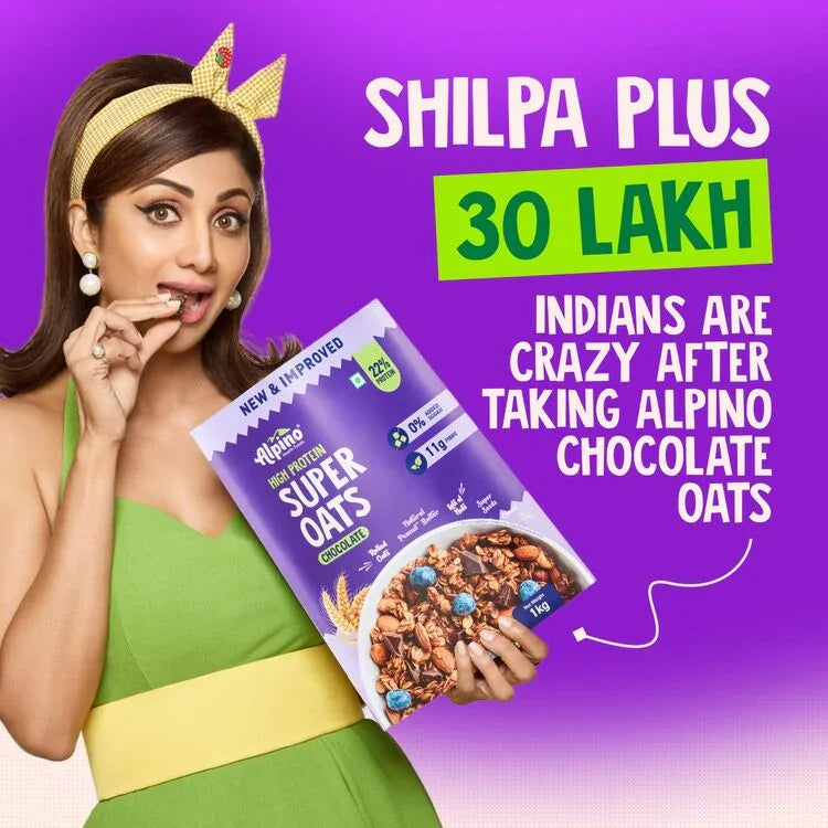 Woman in green dress holding Alpino Super Oats Chocolate pack on purple background with promo text