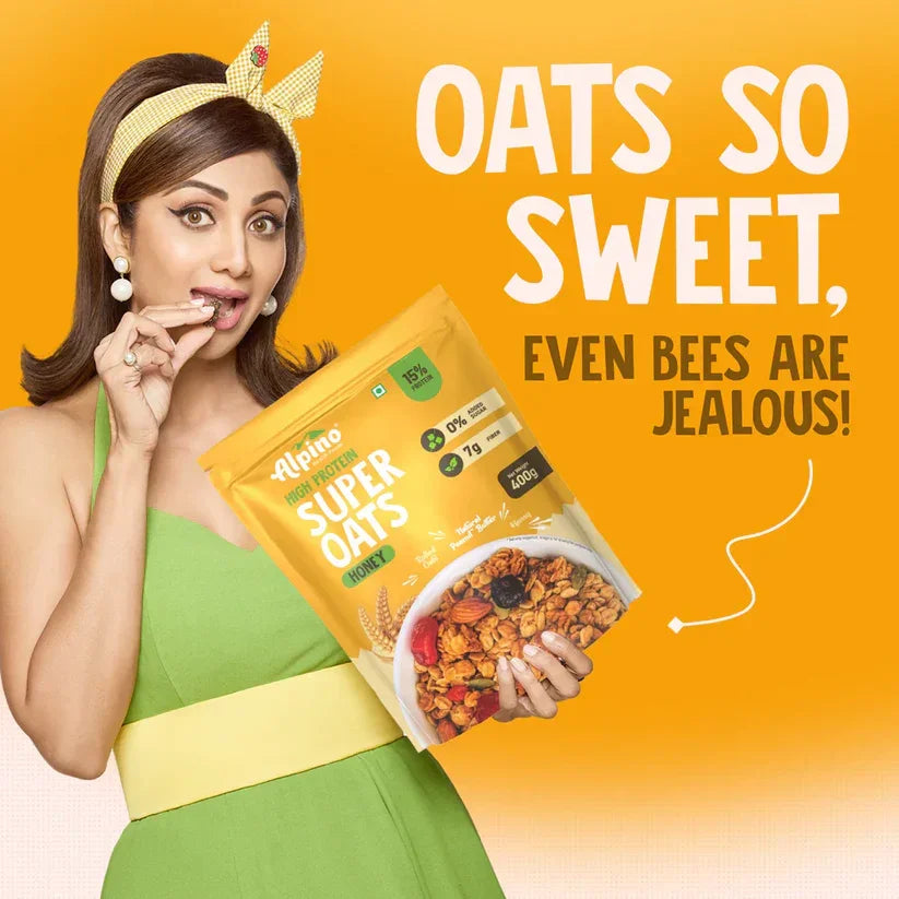 Woman in green dress holding Alpino Super Oats Honey, with text 'Oats so sweet, even bees are jealous'.