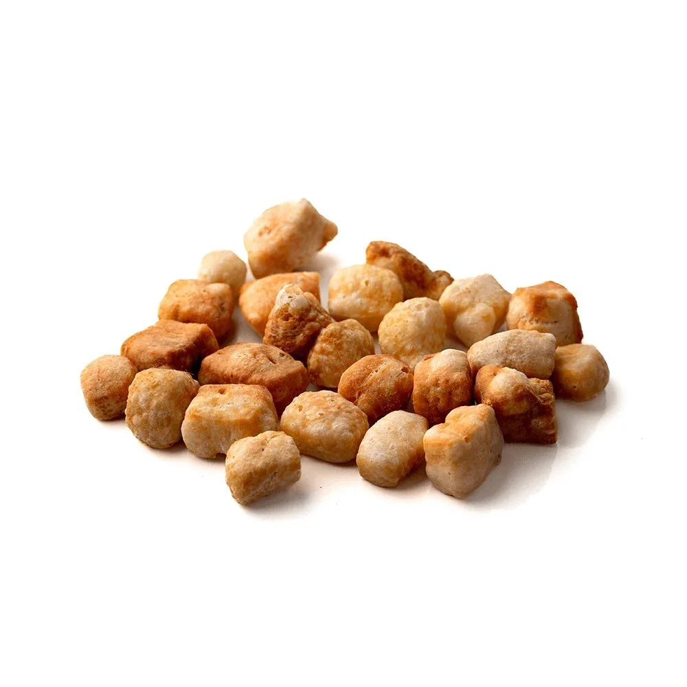Pile of Himalayan yak snak puffs dog treats against white background