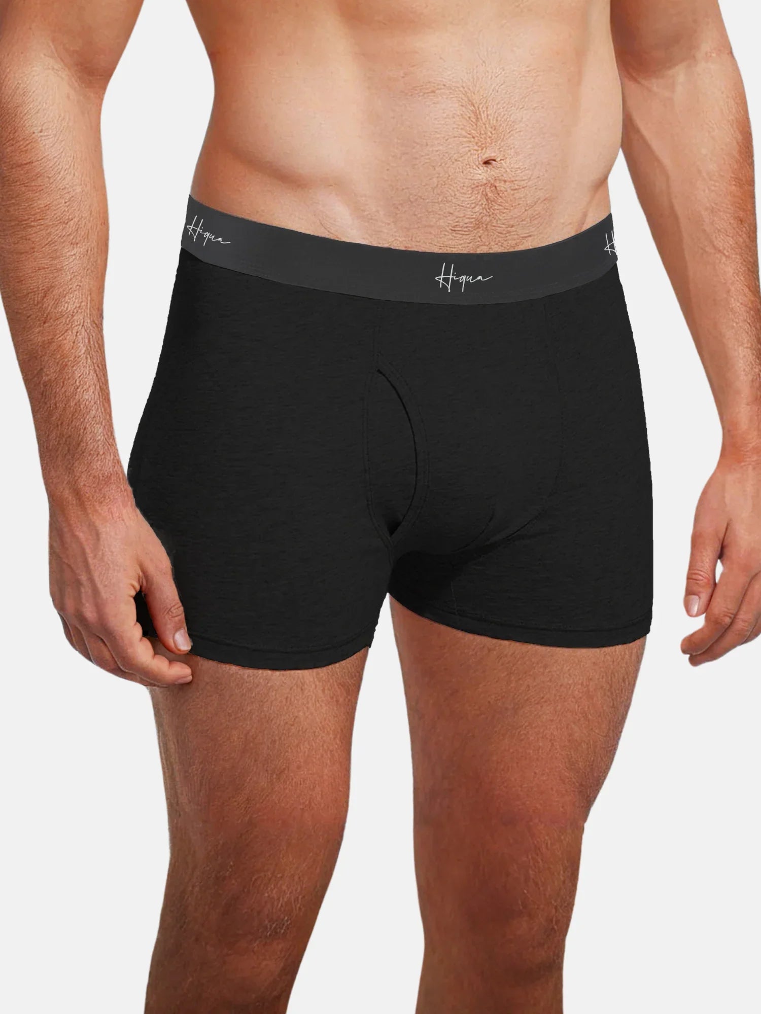 Man wearing black boxer briefs with gray waistband and 'Hiqua' logo, front view
