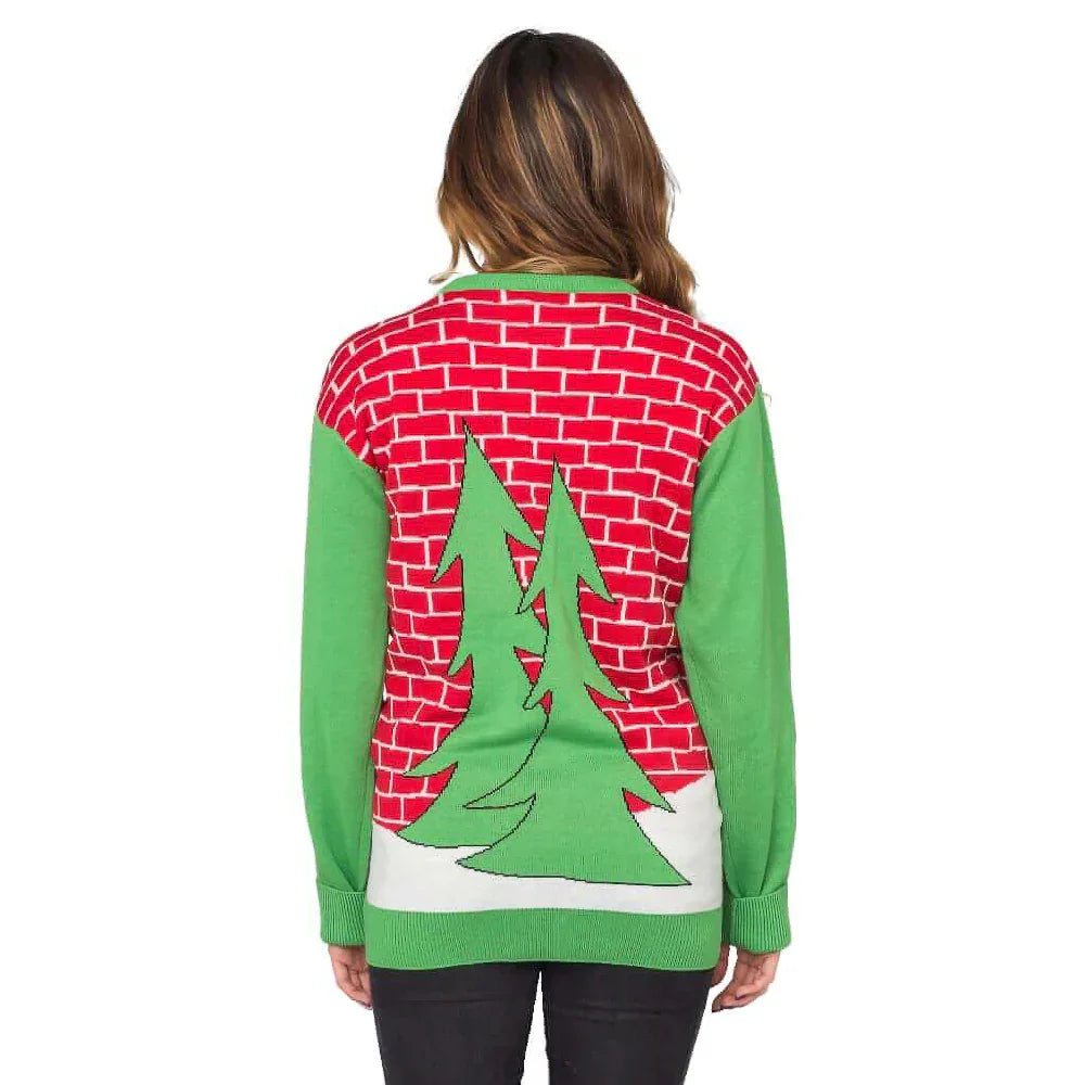 Woman wearing ugly Christmas sweater with red brick, green sleeves, and Christmas tree design