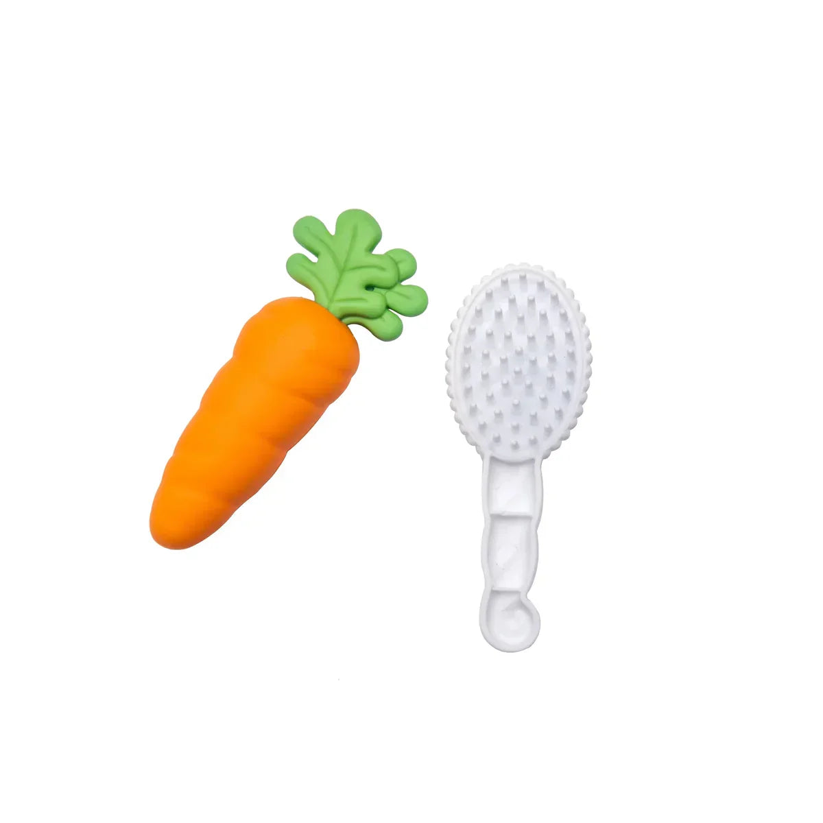 Toy carrot and white grooming brush set on white background
