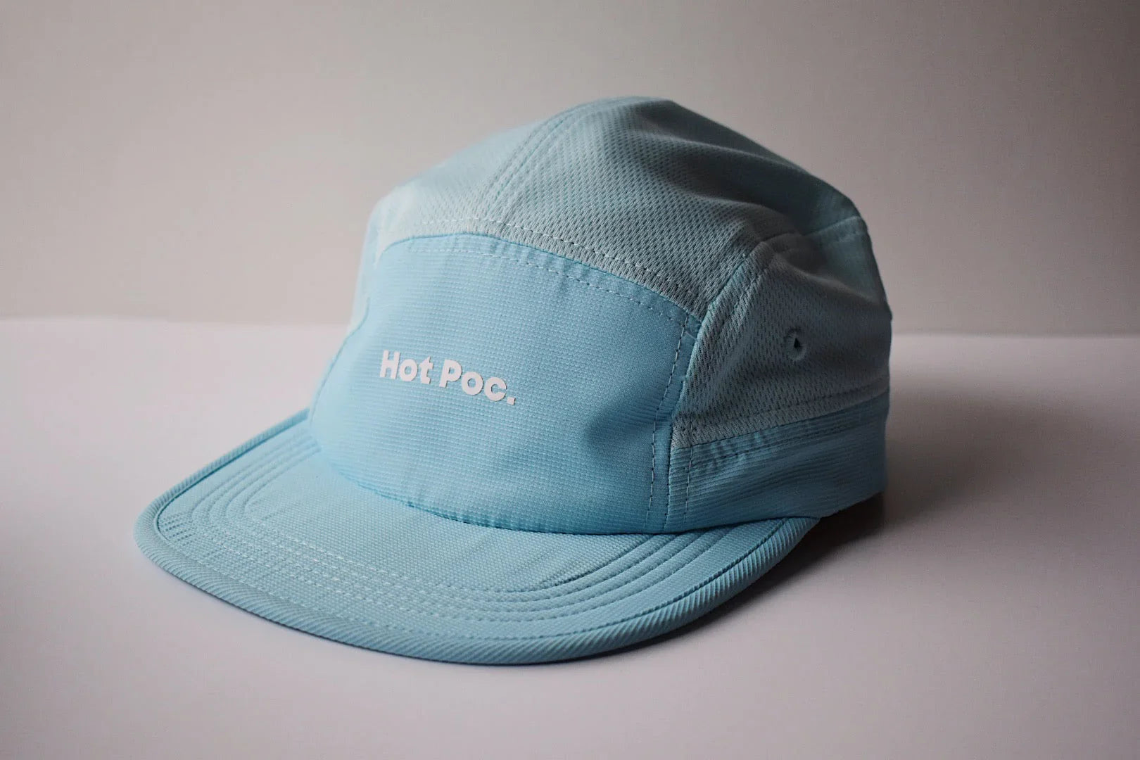 Light blue Hot Poc. cap with mesh panels on a white background