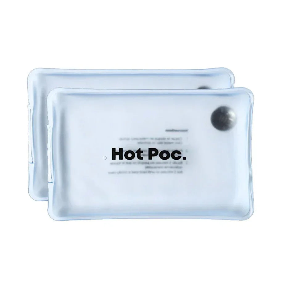 Two clear Hot Poc reusable hand warmers with visible metal disc, stacked on white background