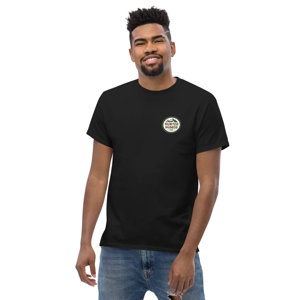 Man wearing black unisex classic tee with Hunter Humor logo, casual jeans, studio background