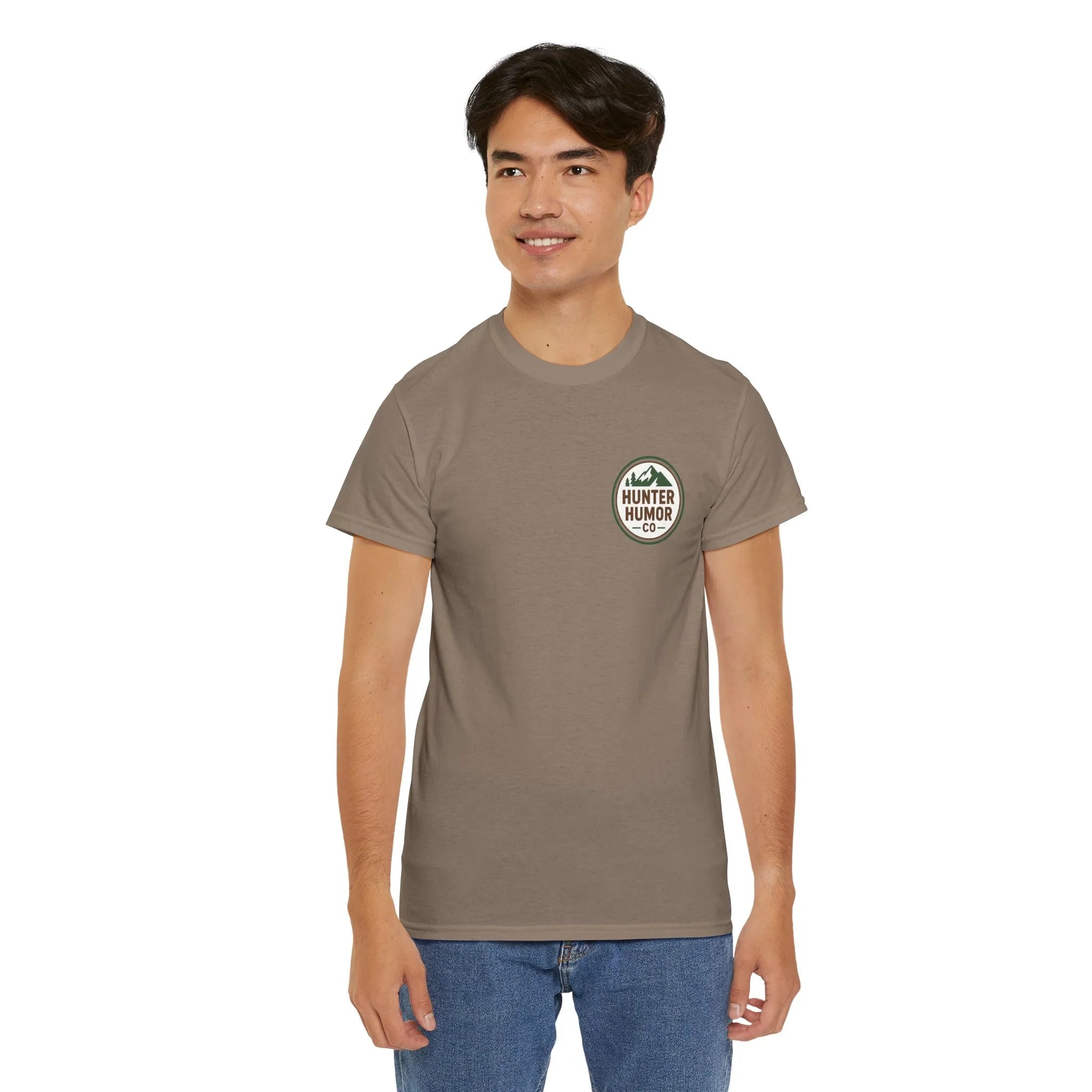 Man wearing taupe Hunter Humor Co t-shirt with logo, standing against white background