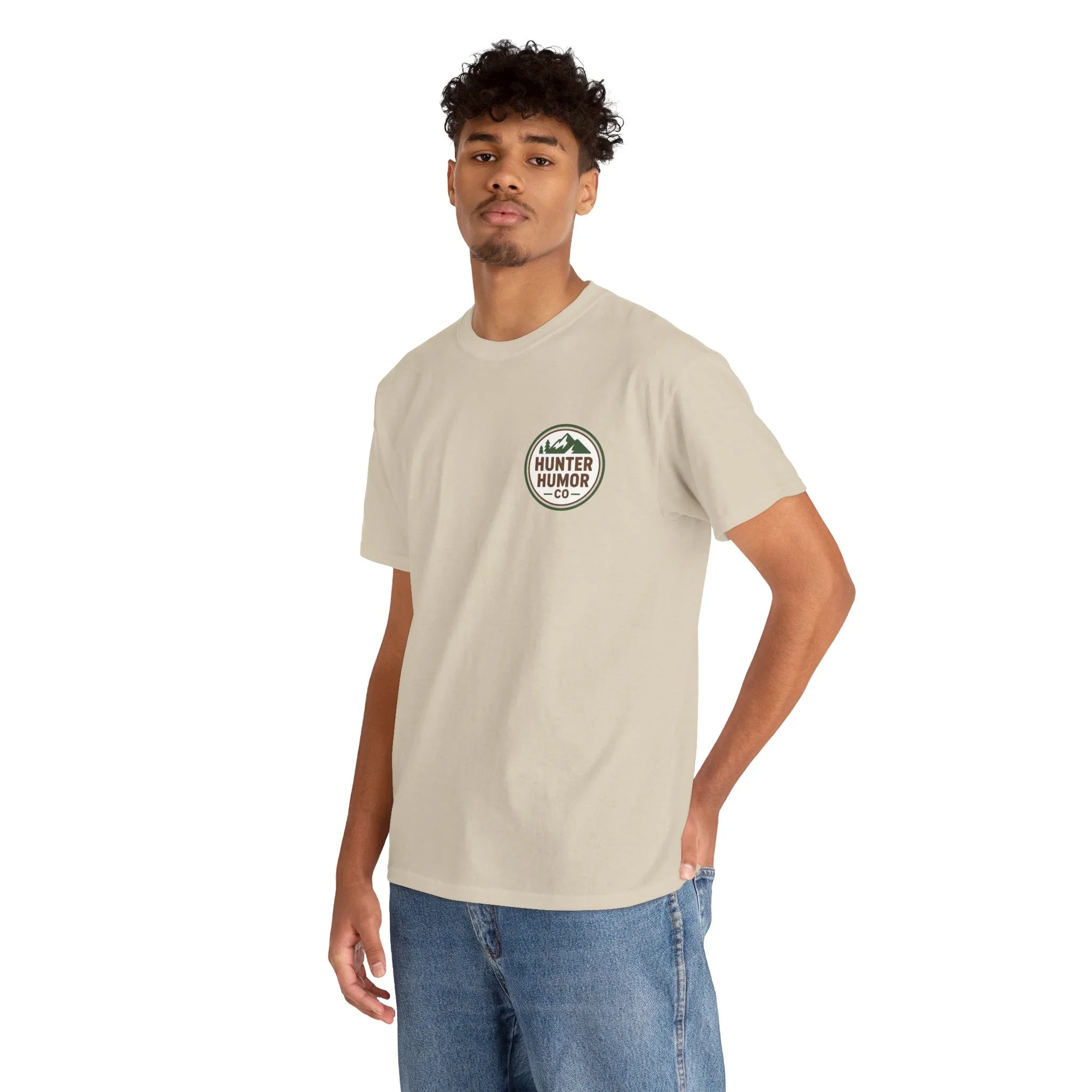 Man in beige Hunter Humor Co. t-shirt and jeans standing against white background