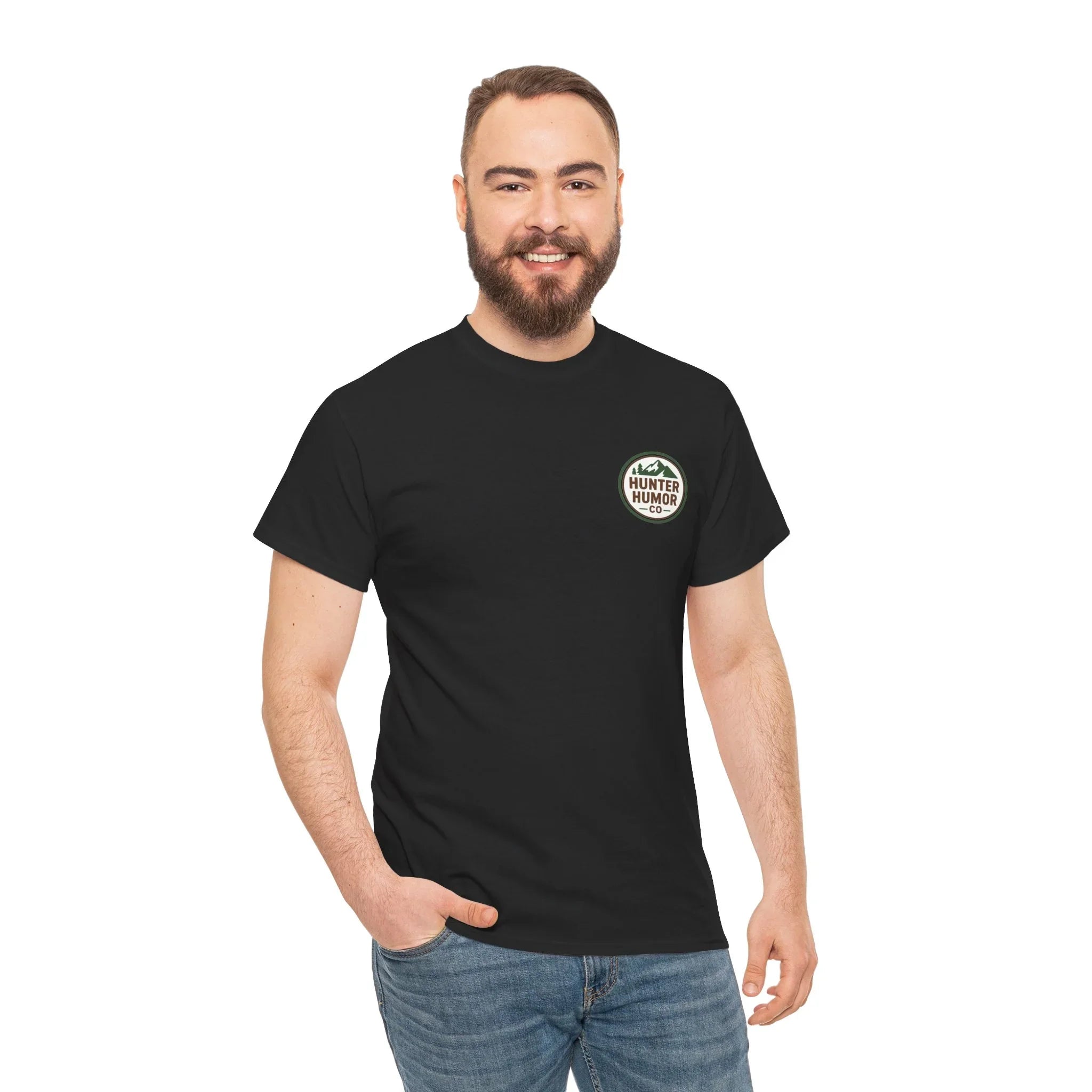 Man in black Hunter Humor Co. t-shirt and jeans, smiling, on white background