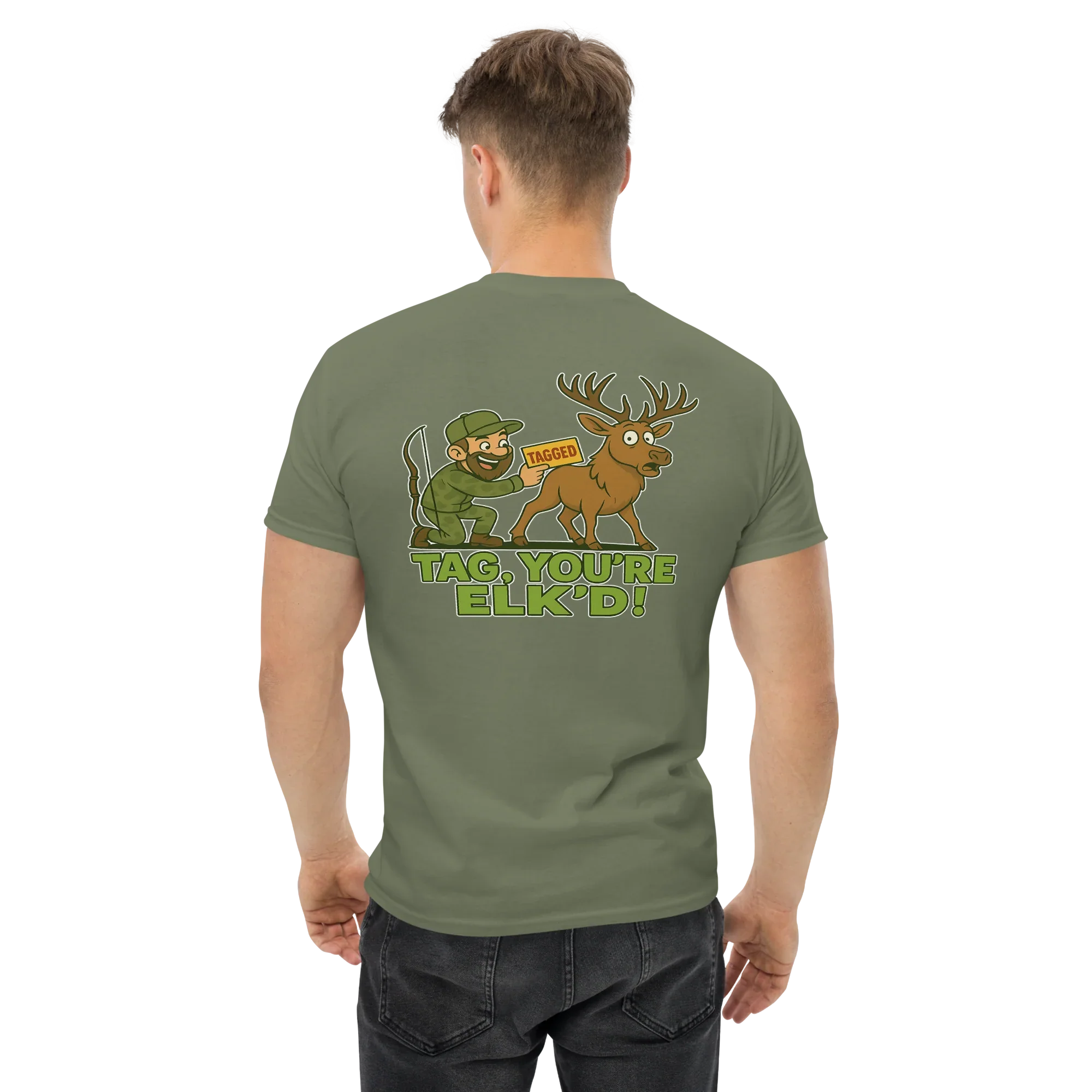 Man wearing a military green tee with cartoon hunter, elk, and 'Tag You're Elk'd!' text on back