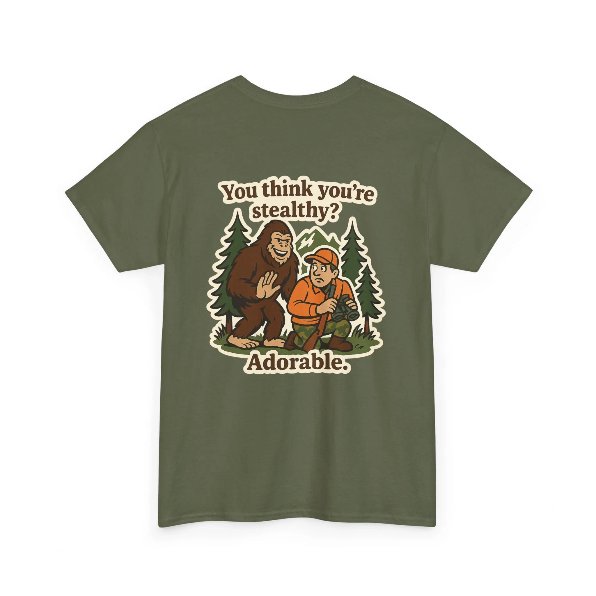 Olive green t-shirt with Bigfoot and hunter cartoon, text says 'You think you're stealthy? Adorable.'