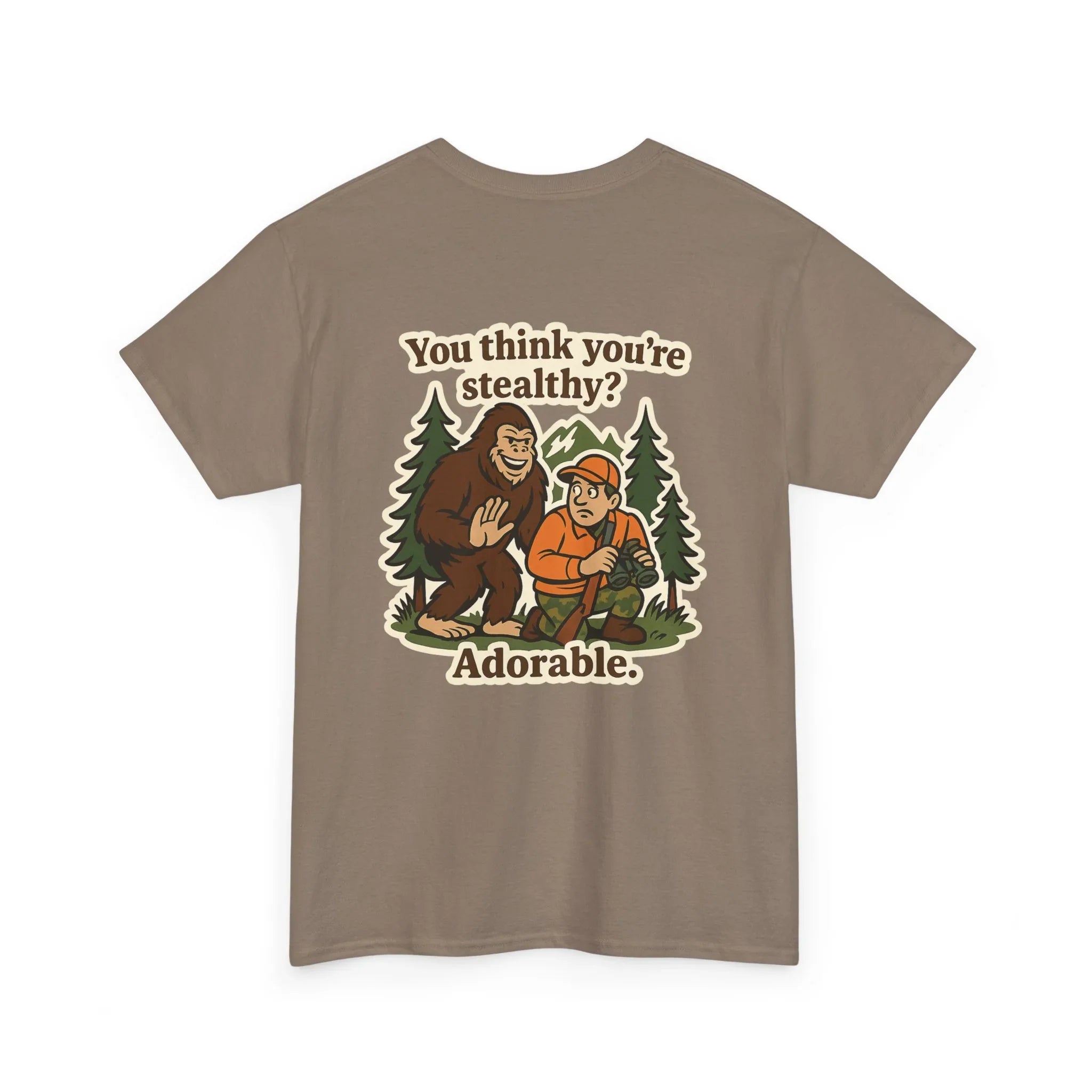 Brown graphic tee with Bigfoot, a hunter, trees, and text 'You think you're stealthy? Adorable.'