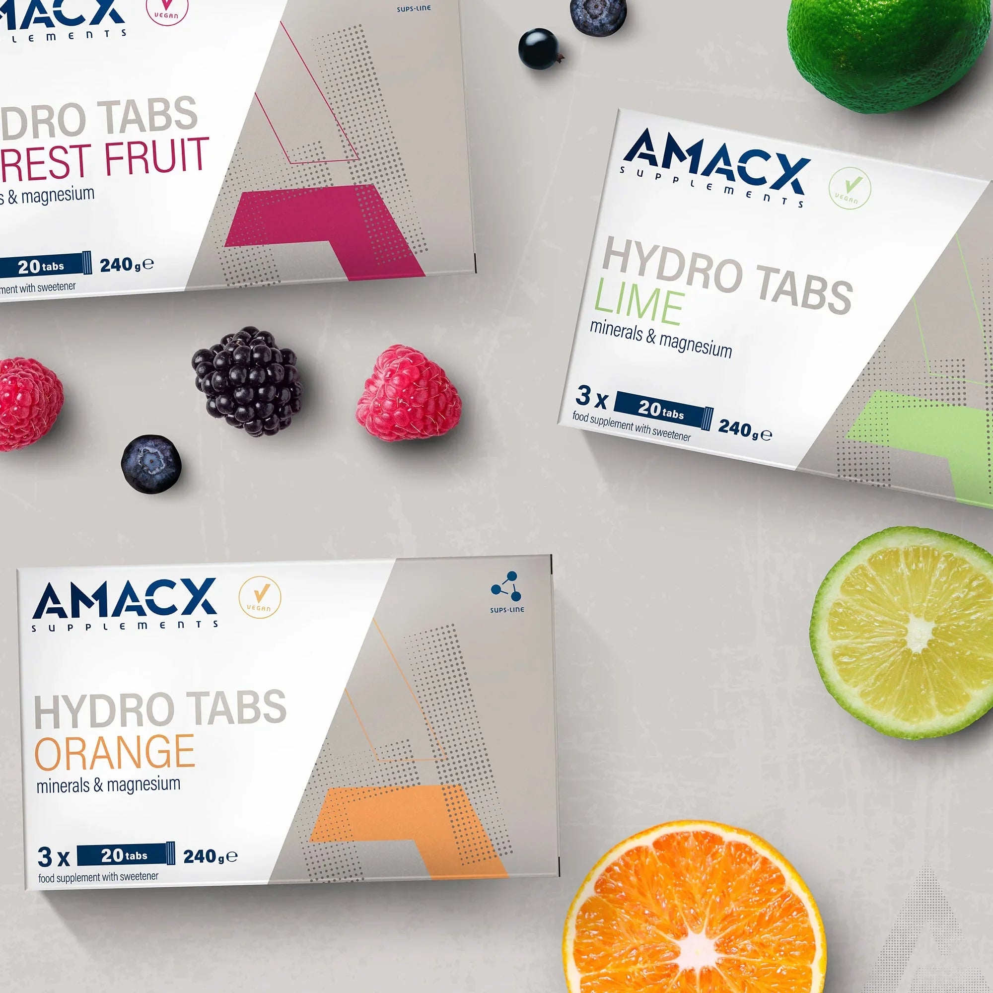 AMACX Hydro Tabs supplements in Forest Fruit, Lime, and Orange flavors with fresh fruits